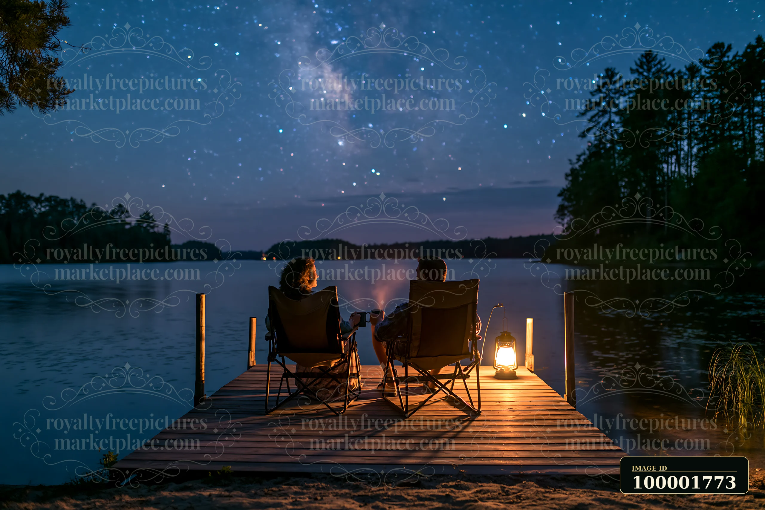 A couple sharing hot drinks under stars sits on a dock by the water.