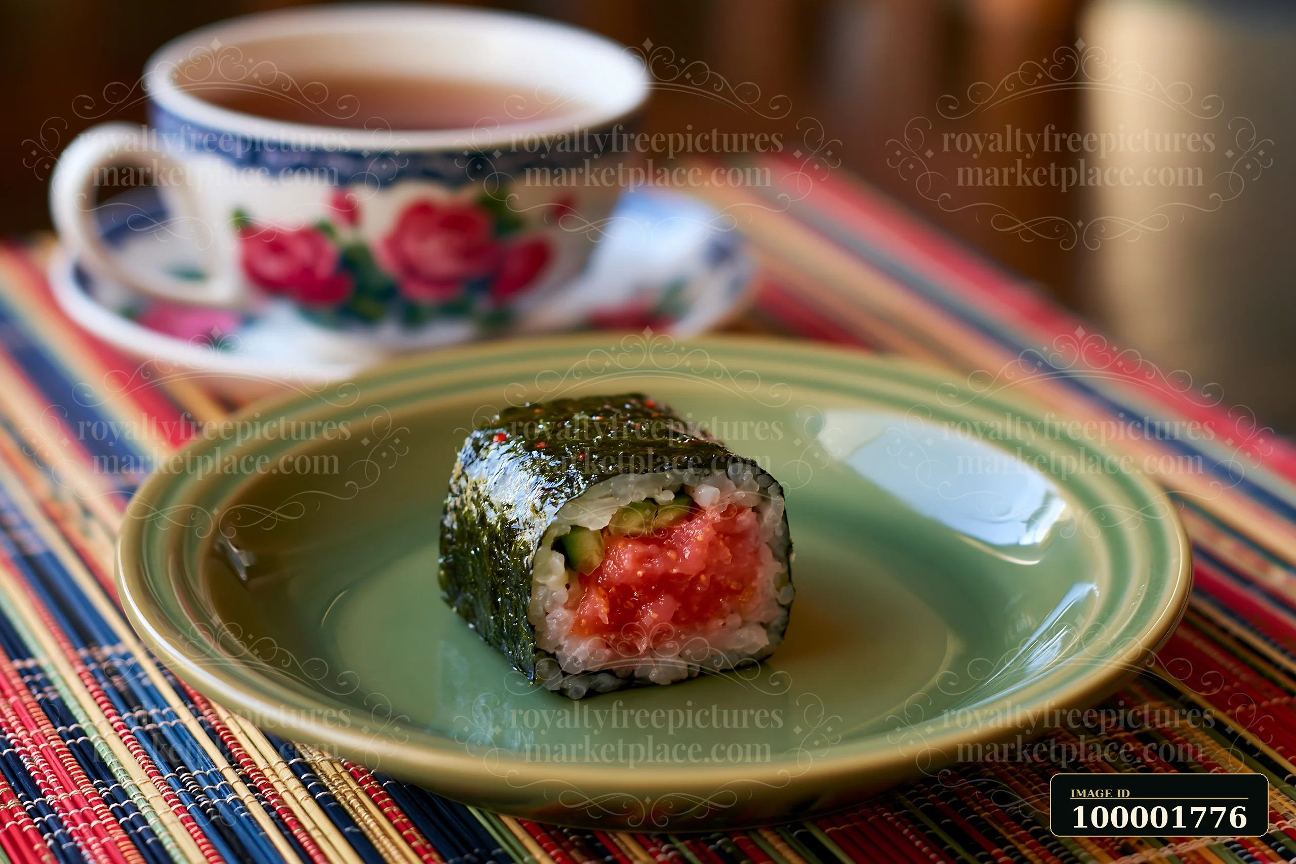 A single spicy tuna roll piece sits on a green plate beside a cup of tea.