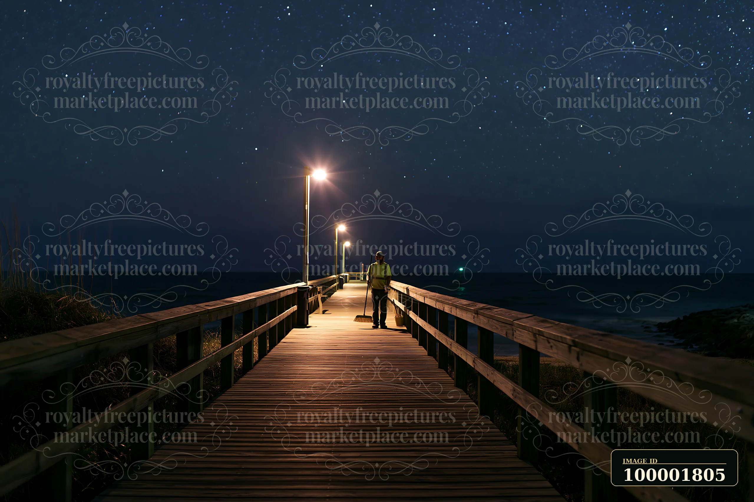 A person strolls along a coastal boardwalk at night, surrounded by a starry sky and bright lights.
