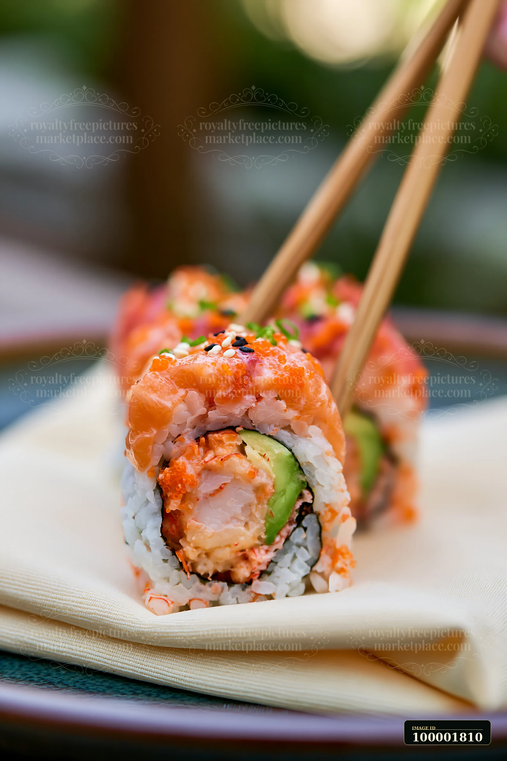 A single sushi piece with chopsticks is placed on a light cloth.