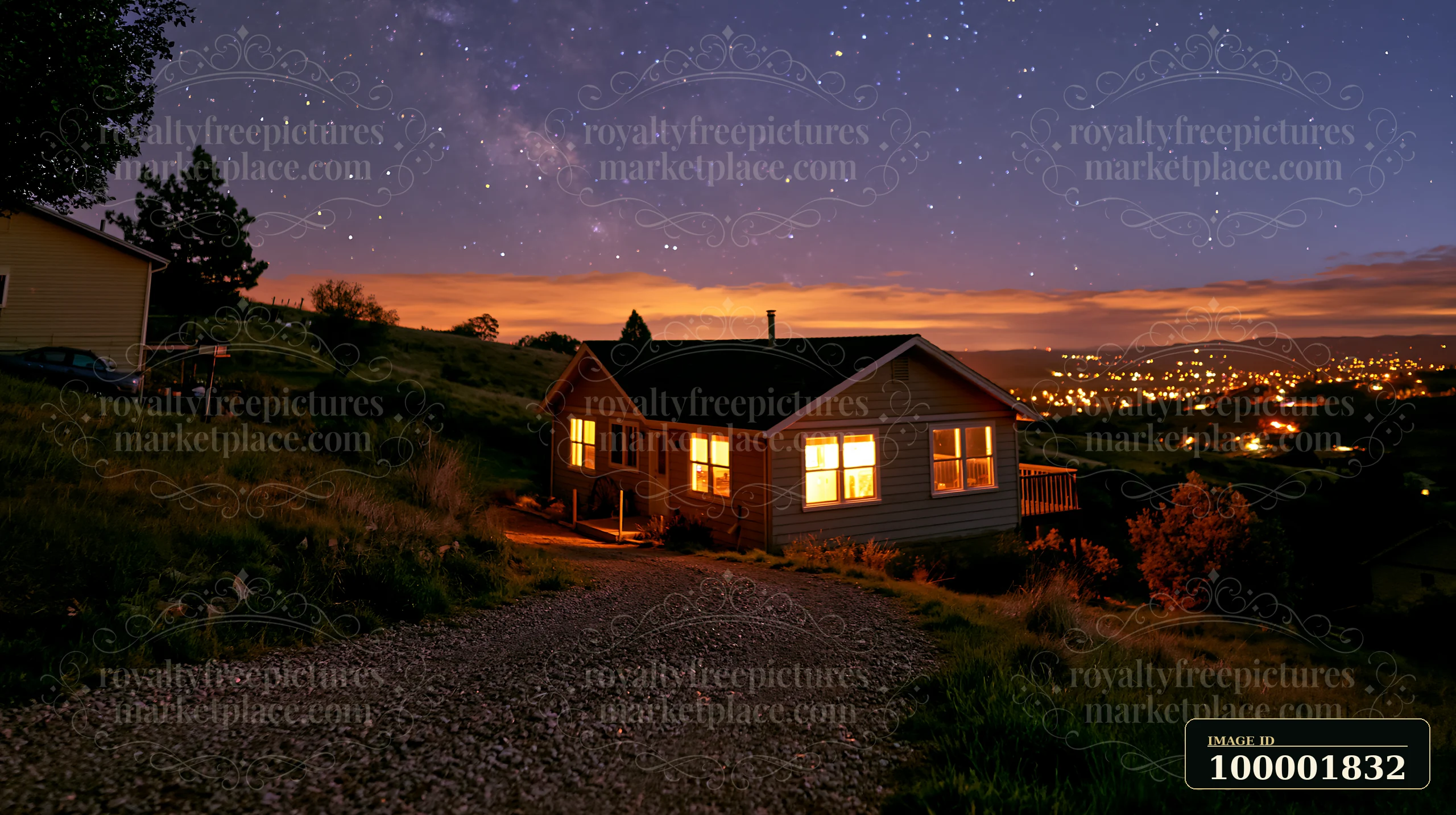 A house sits on a hillside under a night sky filled with stars.