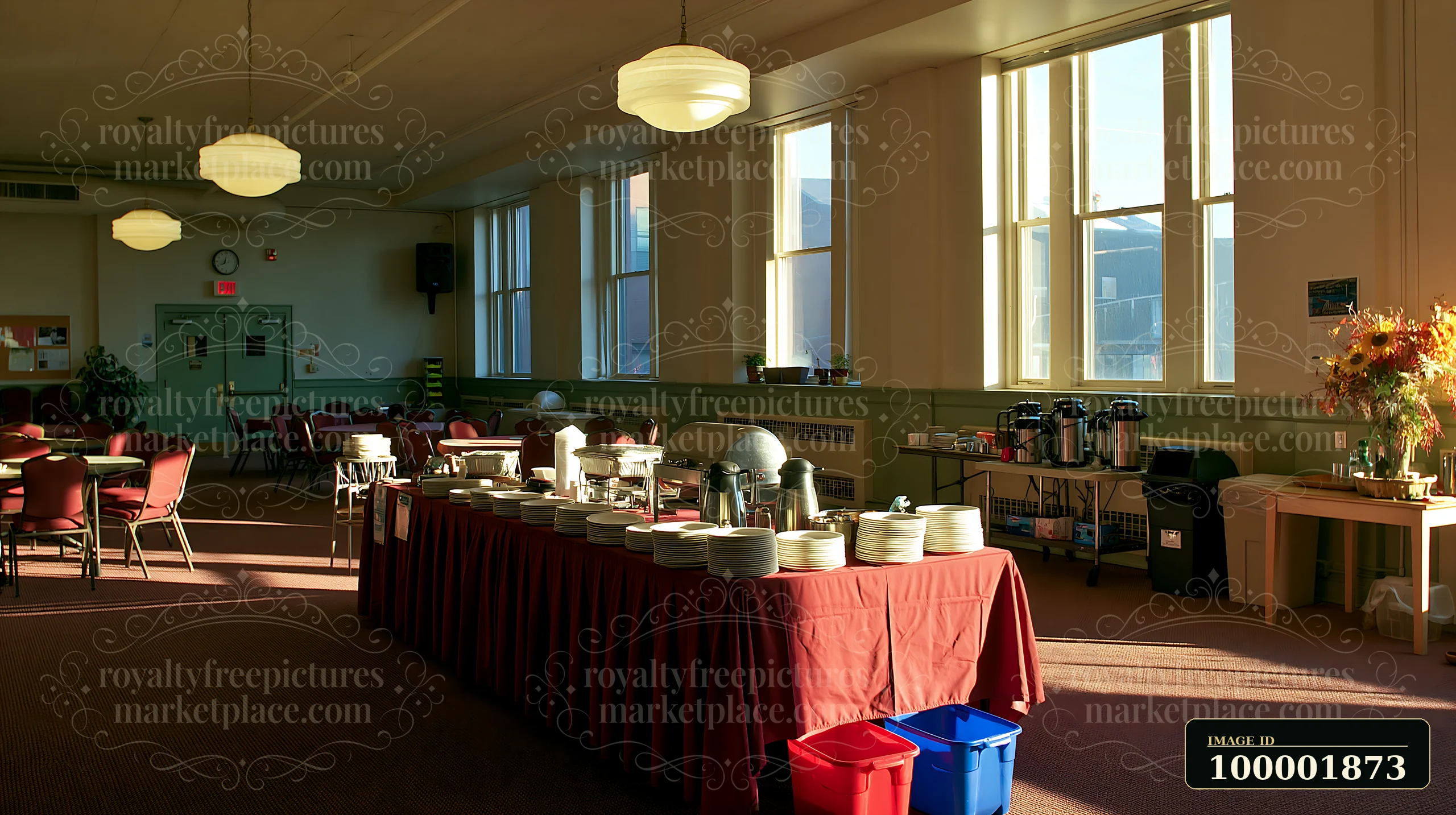 Tables are arranged in a community hall for a church gathering buffet.