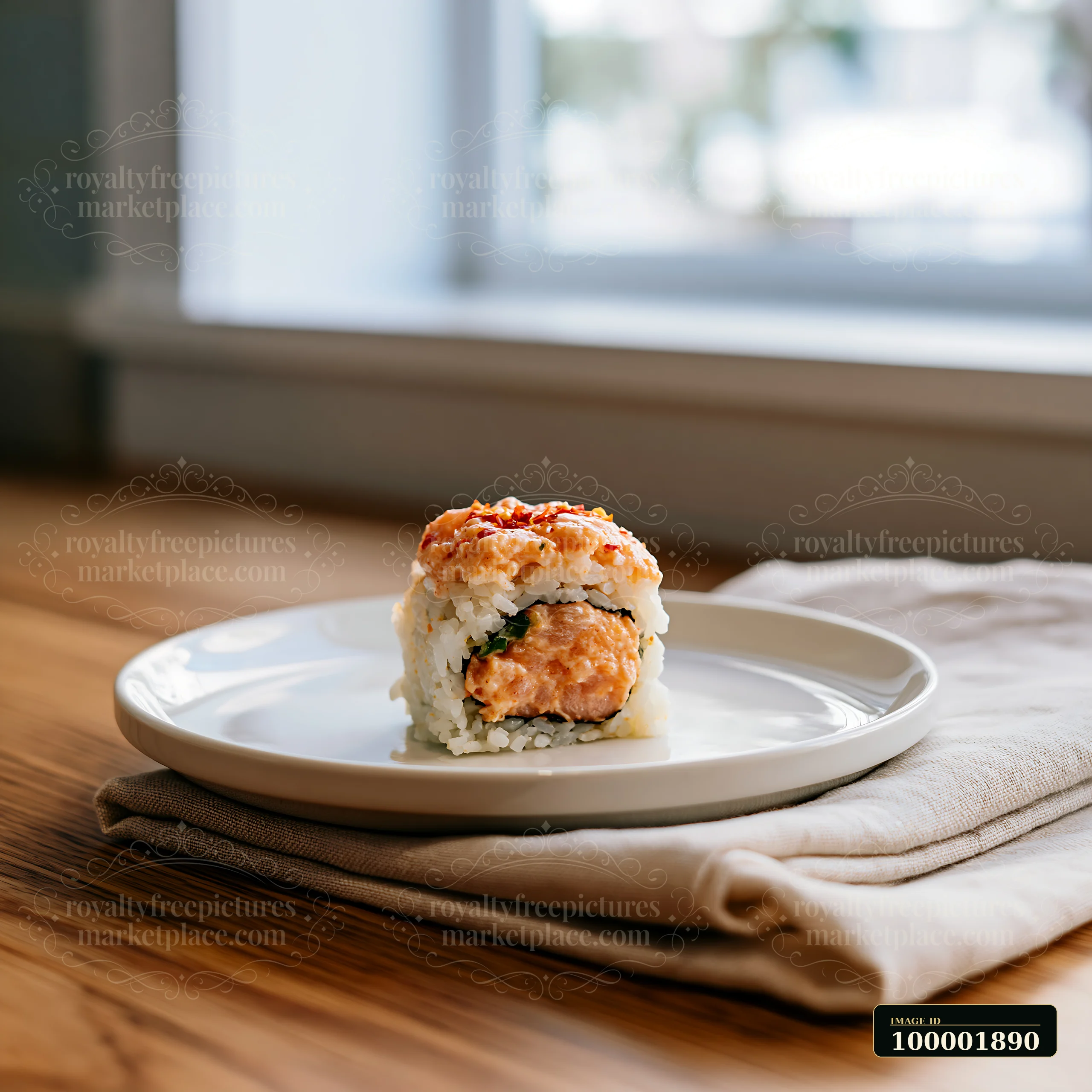 A spicy salmon sushi roll with chili sits on a white plate on a wooden table.