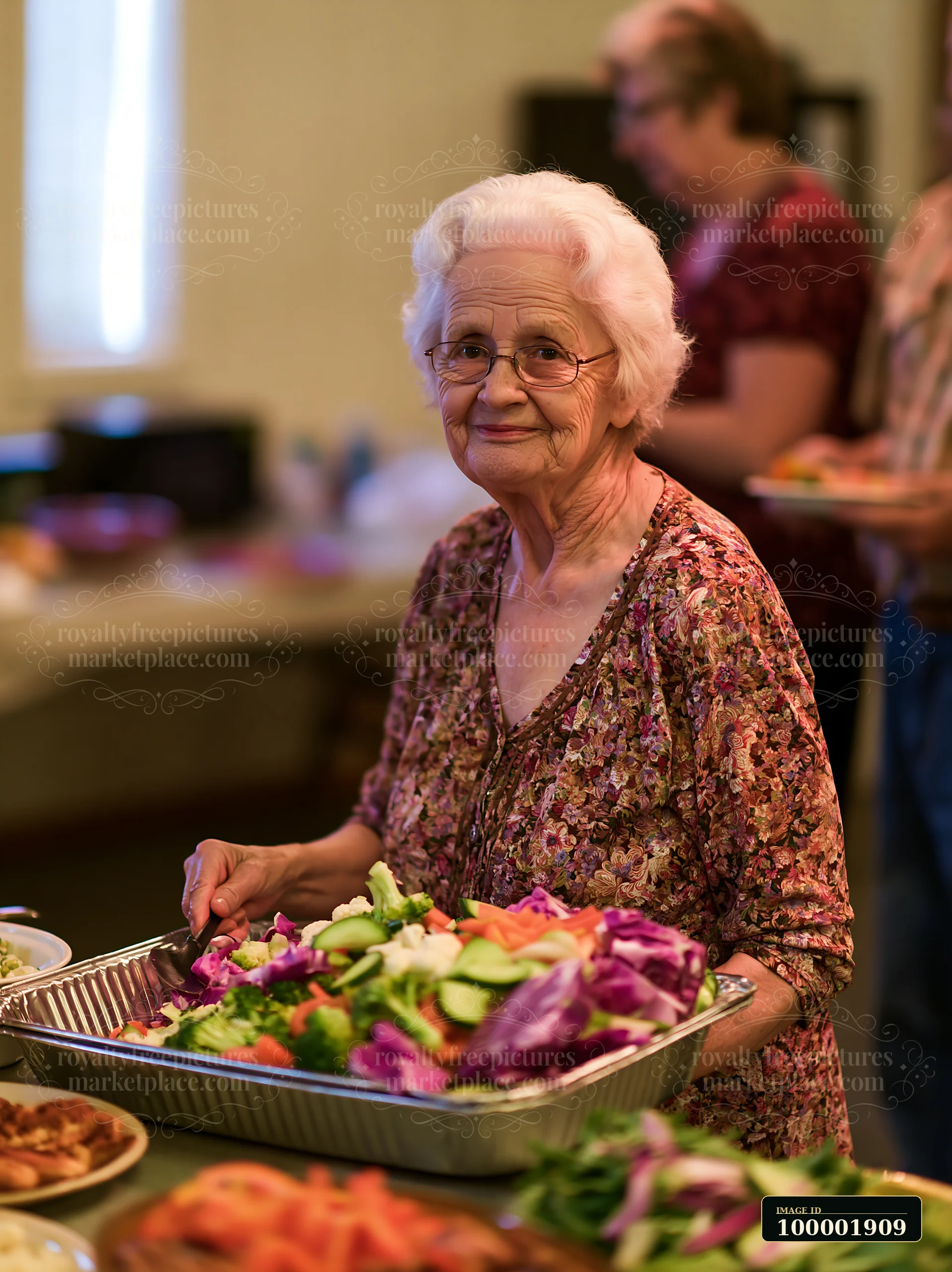 An elderly woman serves a platter of fresh vegetables at a church gathering buffet.