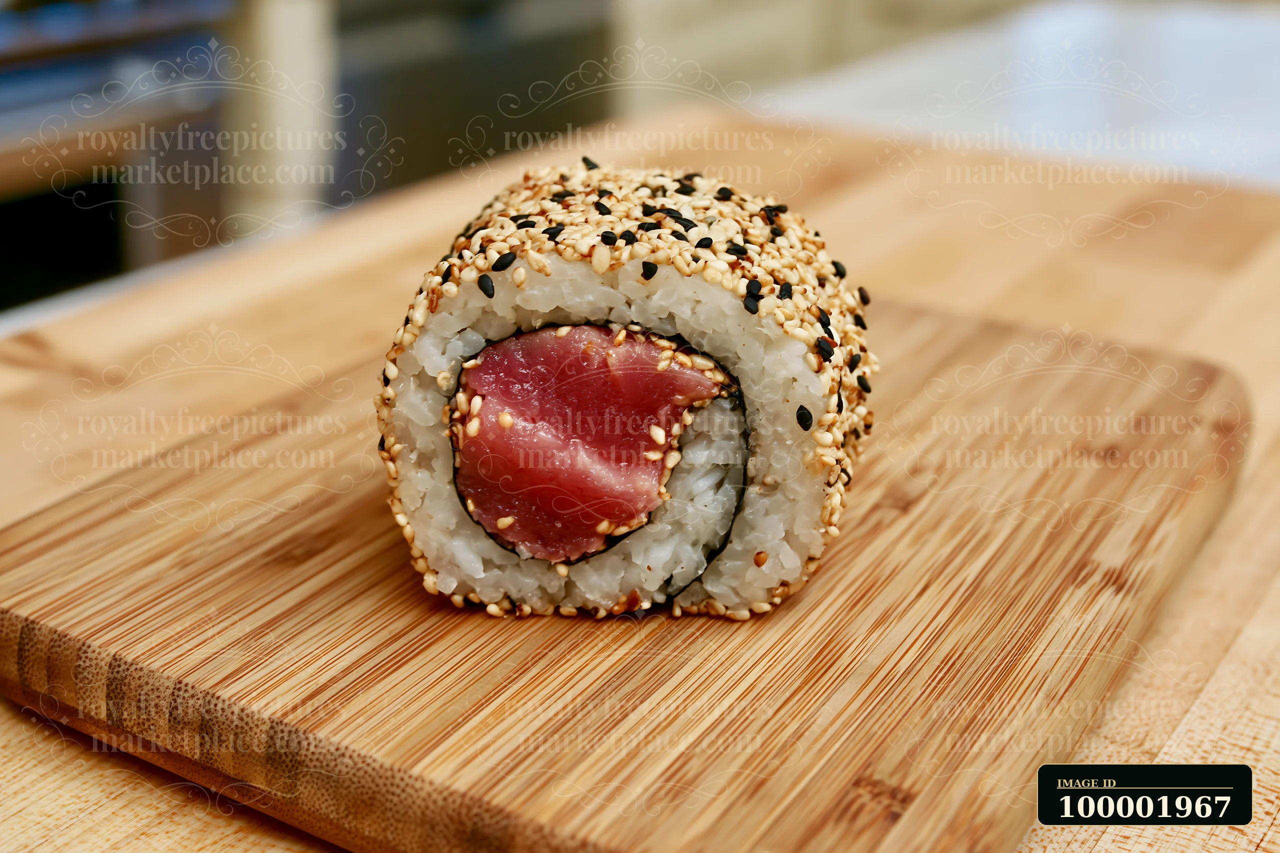 One tuna roll slice with sesame coating sits on a wooden board, showcasing its fresh ingredients.