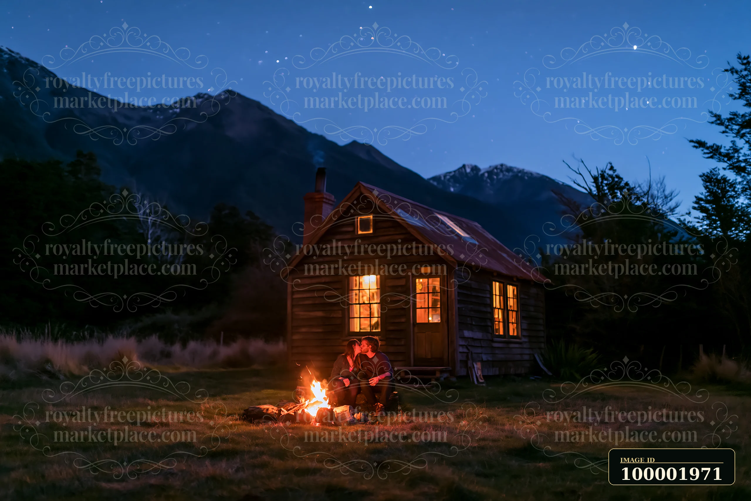 A couple kisses beside a campfire under stars next to a wooden cabin in a mountain setting at night.