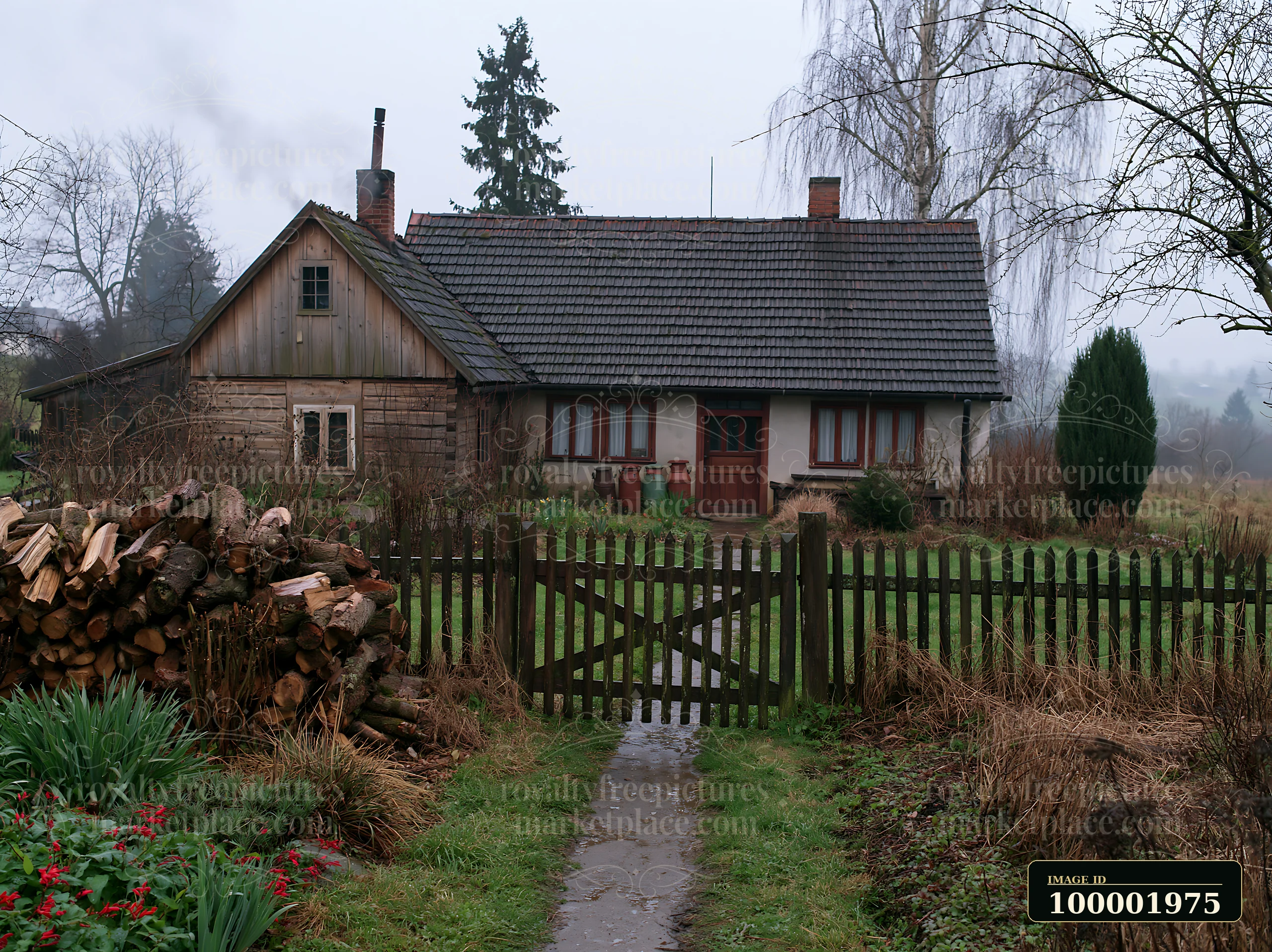 A rural cottage with chimney smoke stands surrounded by a wooden fence.