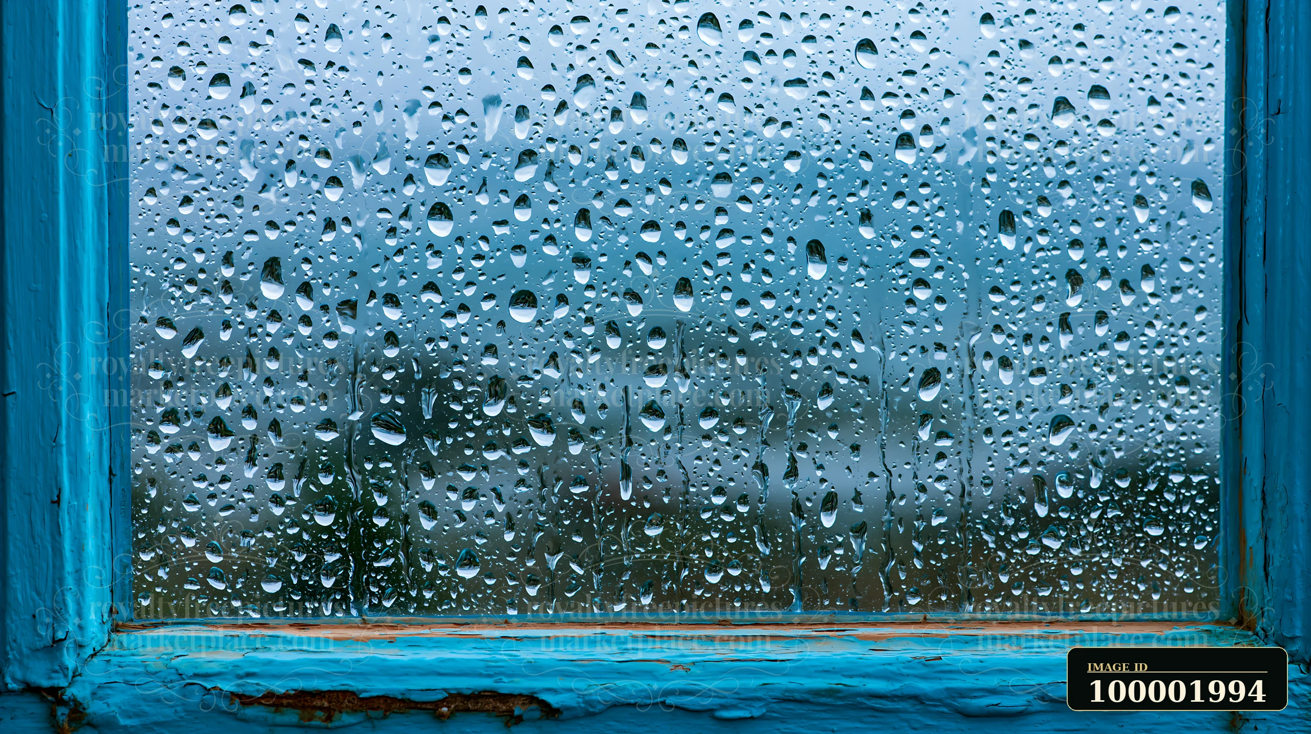 Close-up droplets on rustic glass pane show rainwater clinging to the surface.