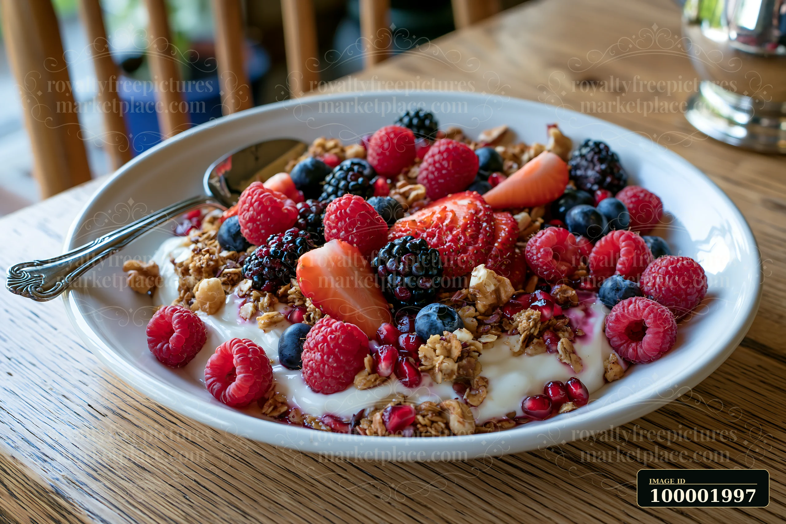 This healthy breakfast plate features yogurt topped with granola, fresh berries, and pomegranate seeds, served on a rustic wooden table.