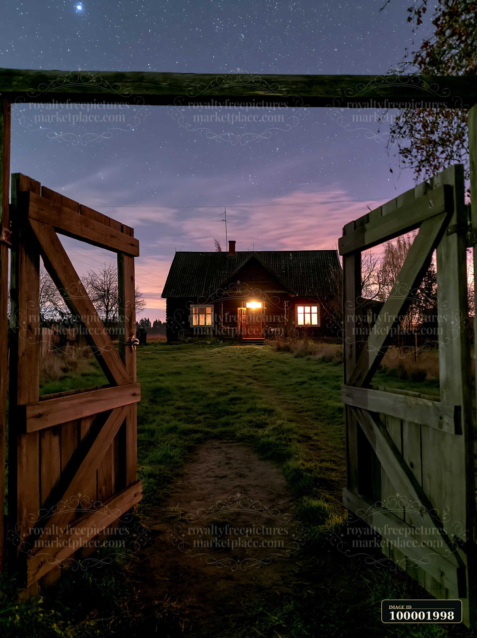 A farmhouse beneath night sky glows softly as stars shine above.