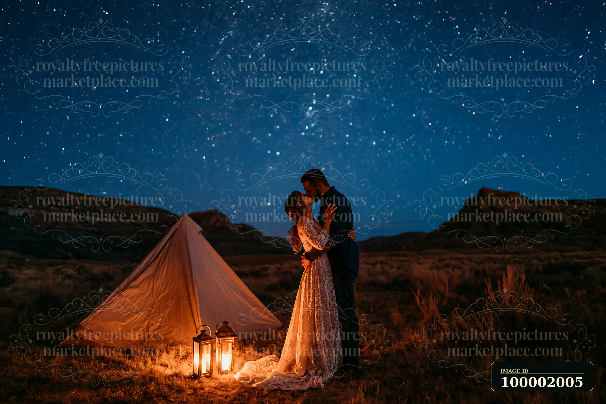 A couple kissing under a starry sky stands close to a tent with lanterns.