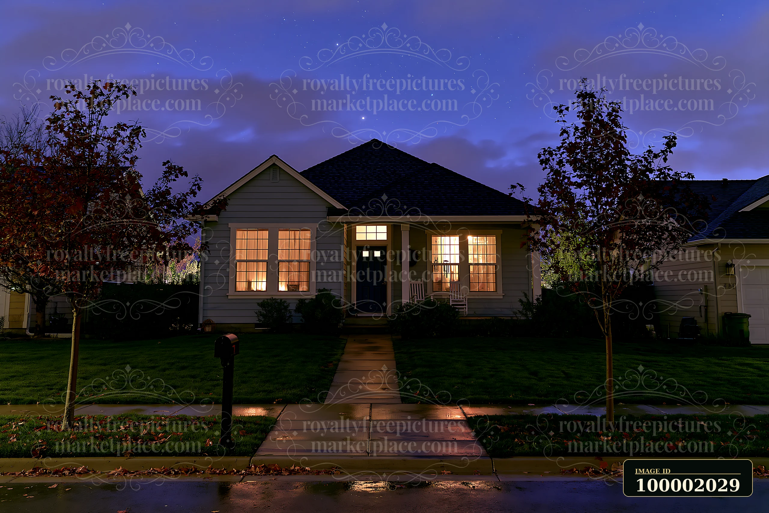 A house stands under a clear night sky as stars appear during blue hour.