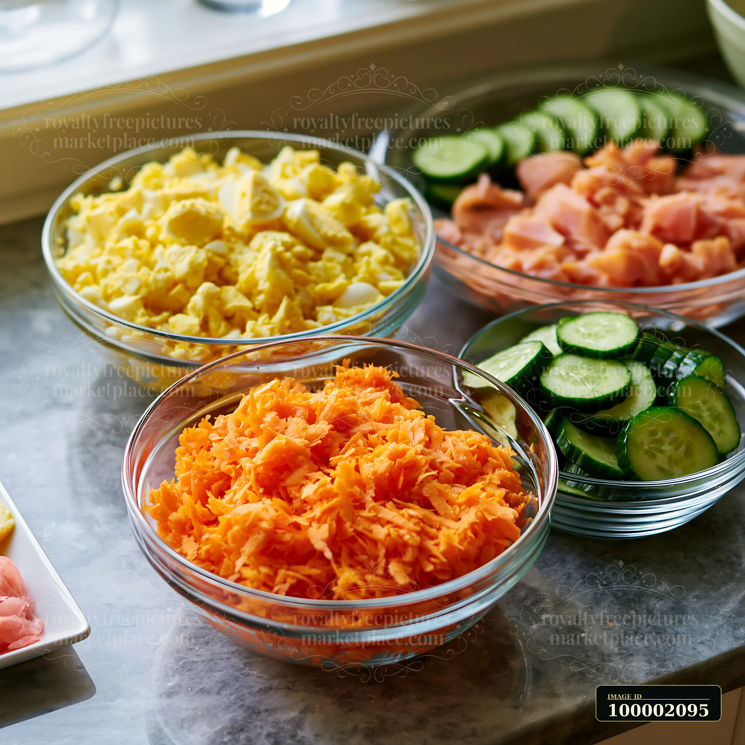 Brightly colored sushi ingredients arranged on a counter include shredded carrots, slices of salmon, chopped cucumbers, and scrambled eggs in clear bowls, ready