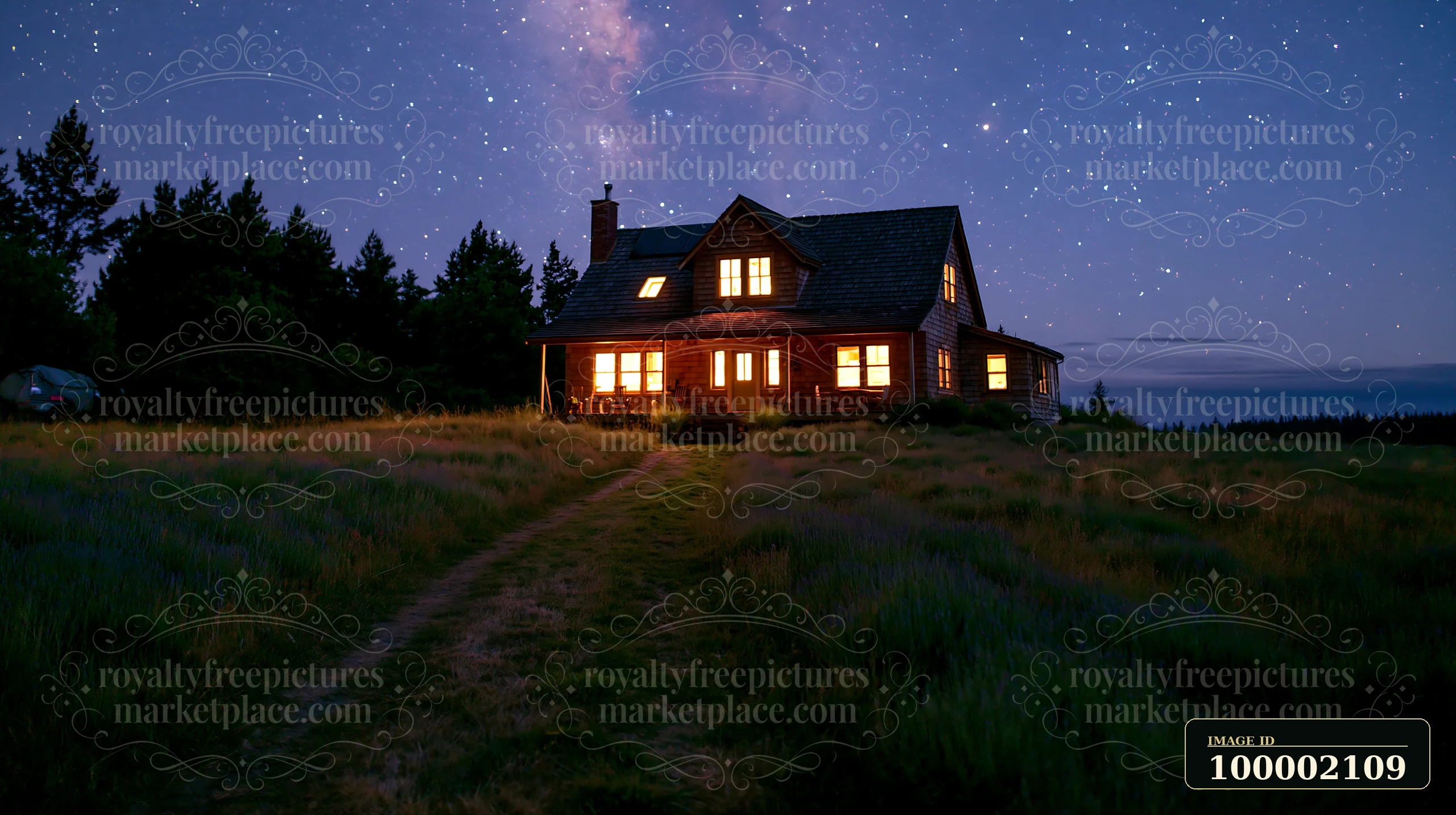 A holiday home under stars stands with warm lights visible through its windows.