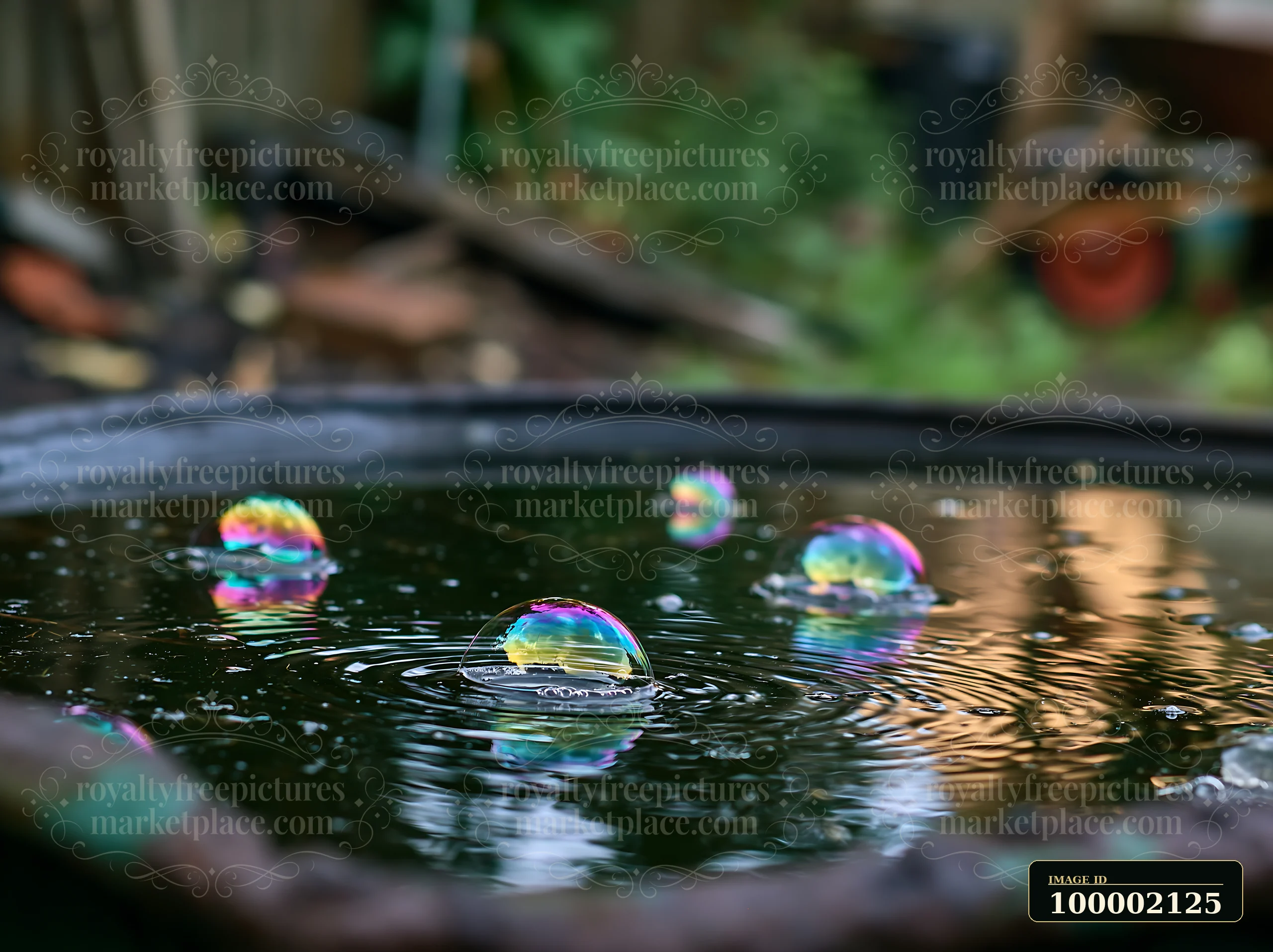 Rainbow oil droplets on water surface create vibrant reflections.
