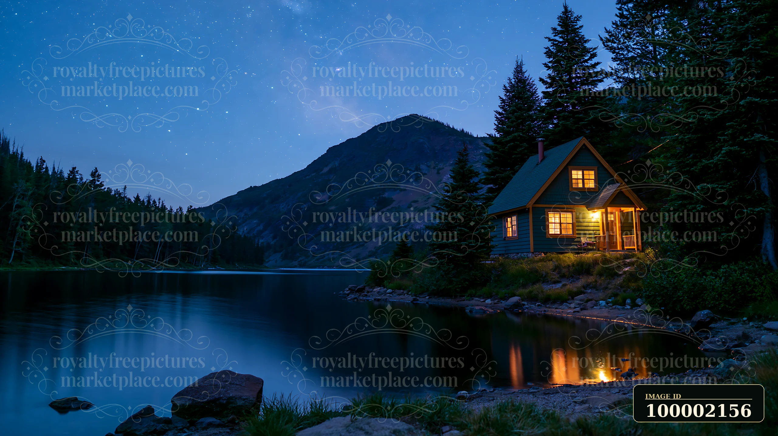 A holiday home under stars sits beside a calm lake with a mountain in the background.