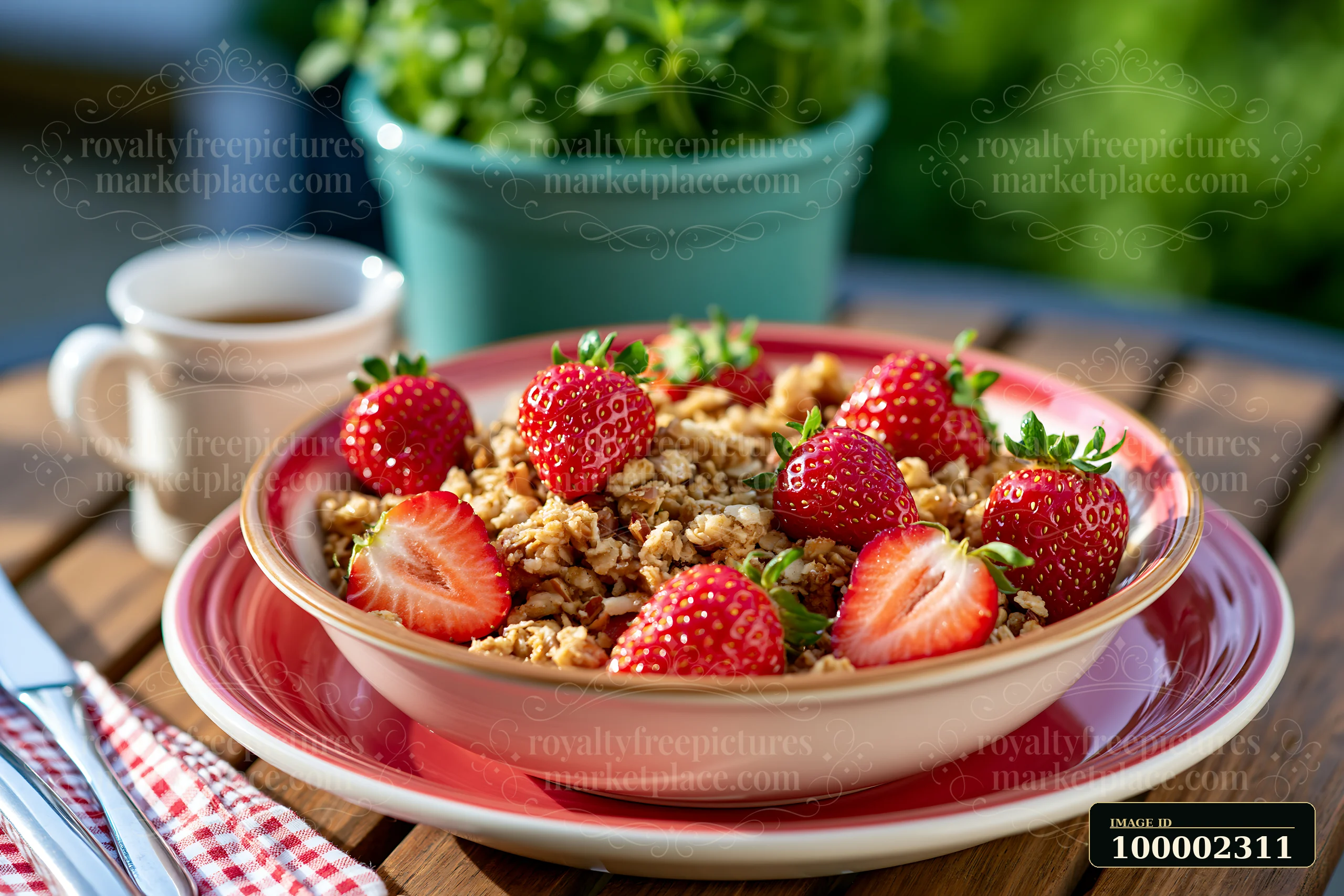 A breakfast plate with muesli topped with strawberries sits on a wooden table.