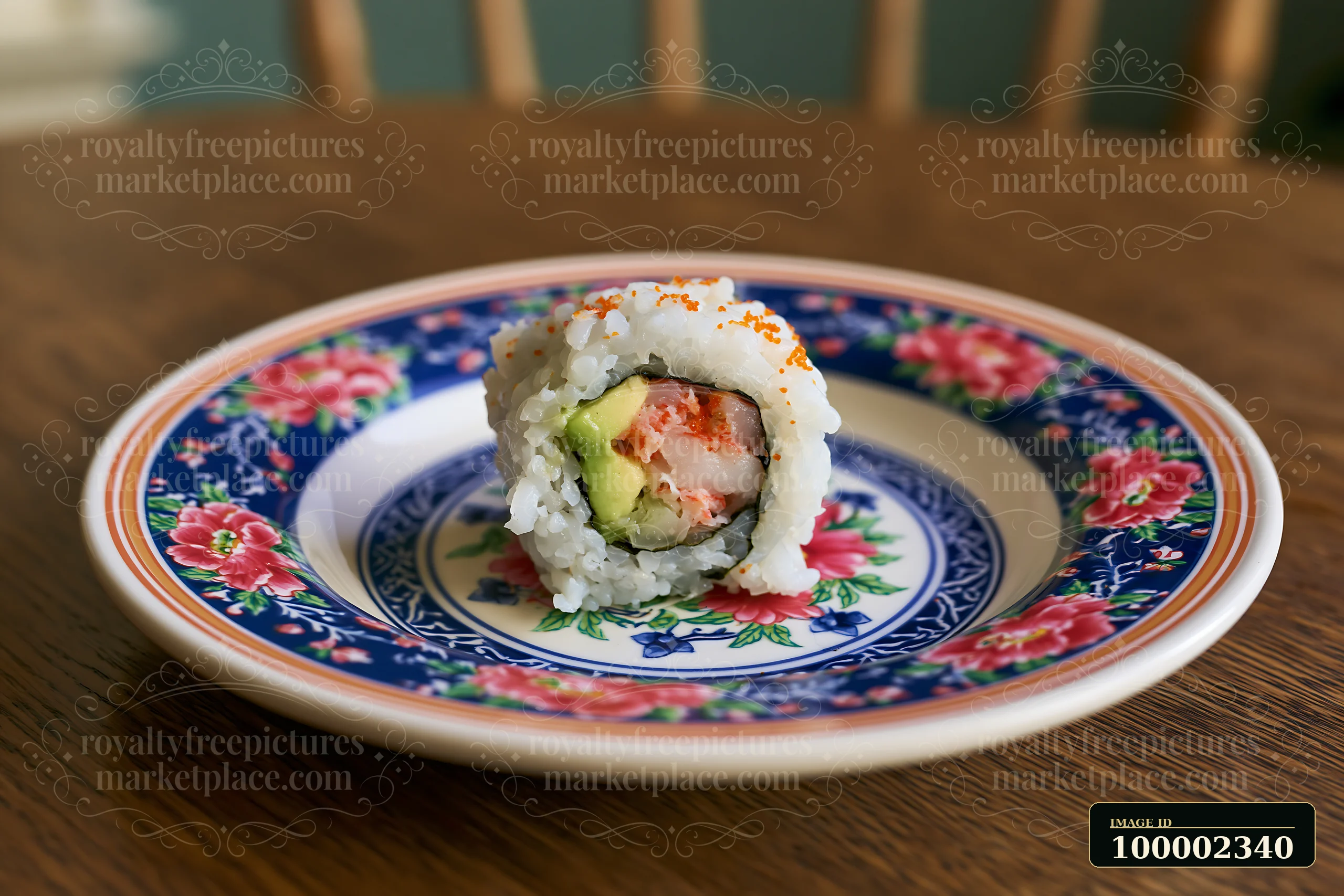 One California roll piece on plate sits on a floral patterned dish.