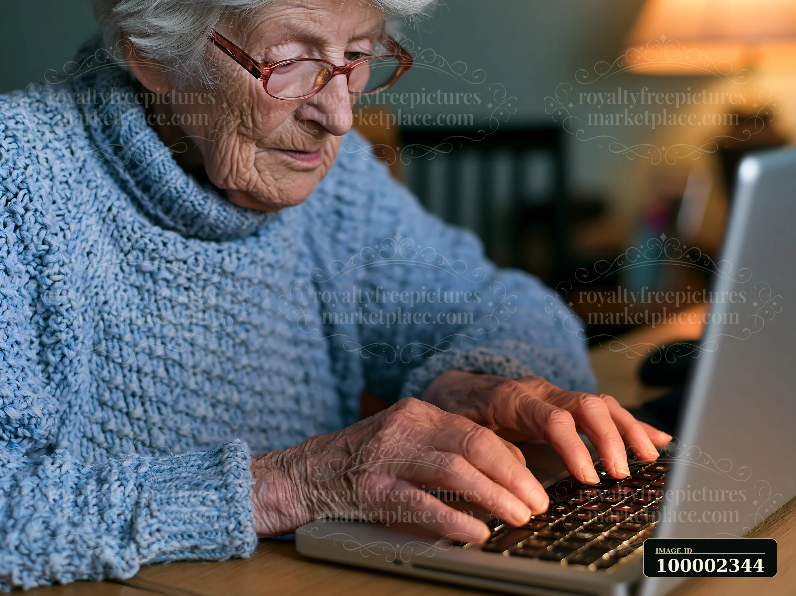 A senior woman sits at a wooden table in her cozy home, trying to type on a laptop with shaky hands.