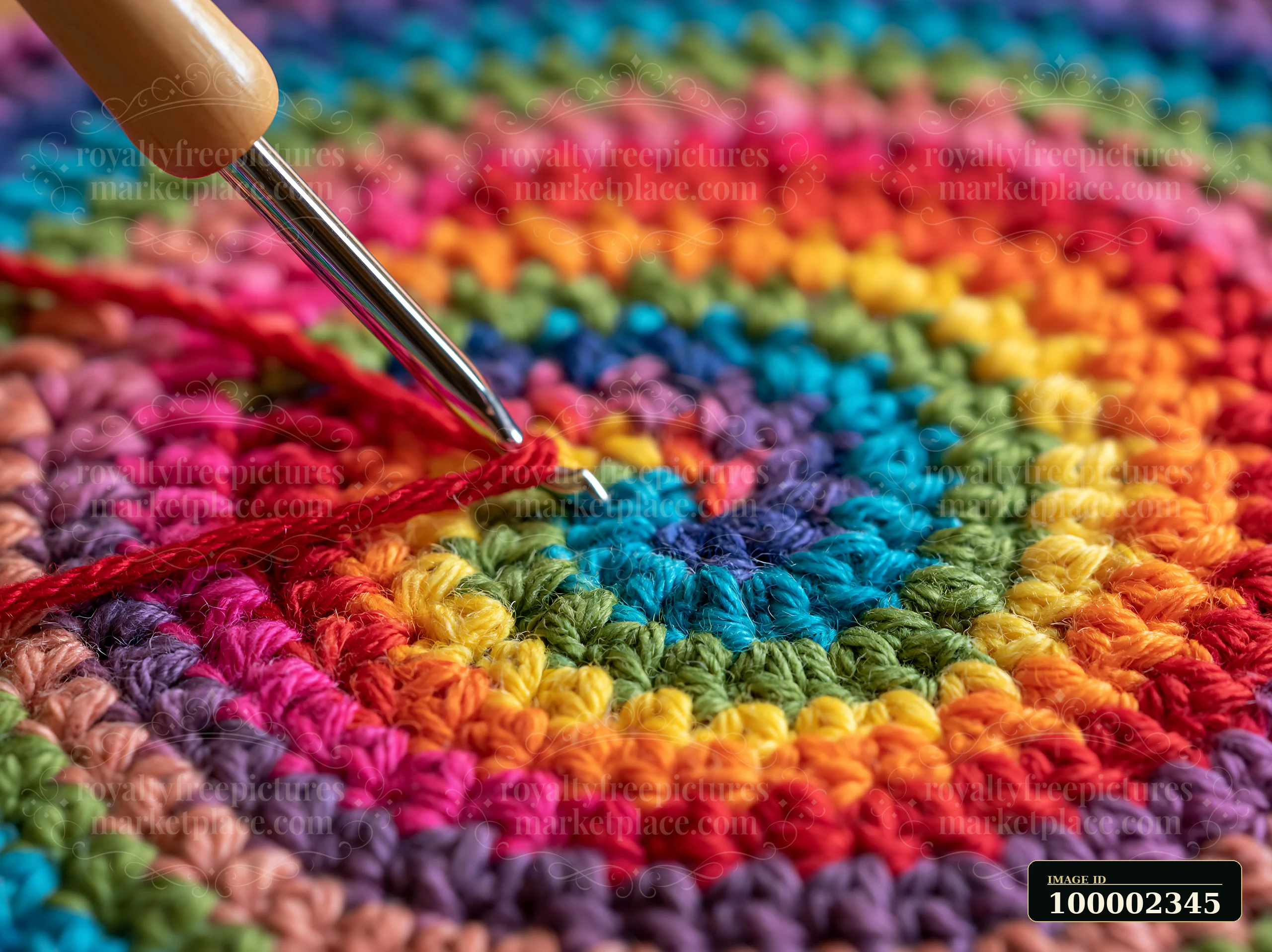 A crochet hook pulls rainbow thread wound in spiral through colorful yarn on a crafting surface.