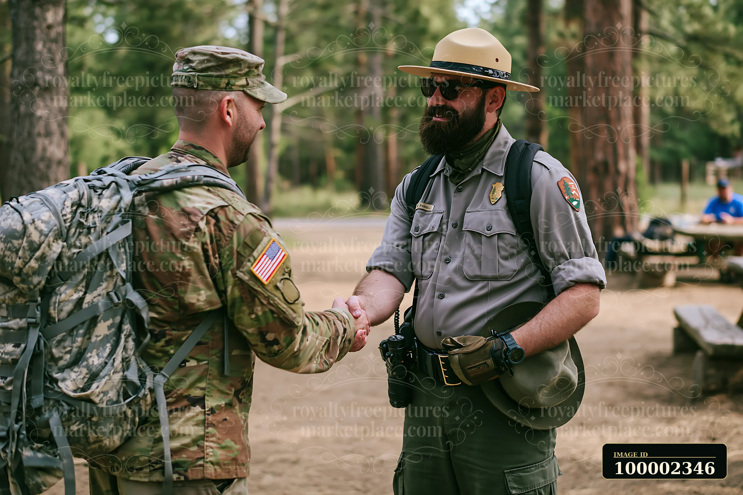 A soldier shaking hands with a park ranger in a wooded area during a sunny day.