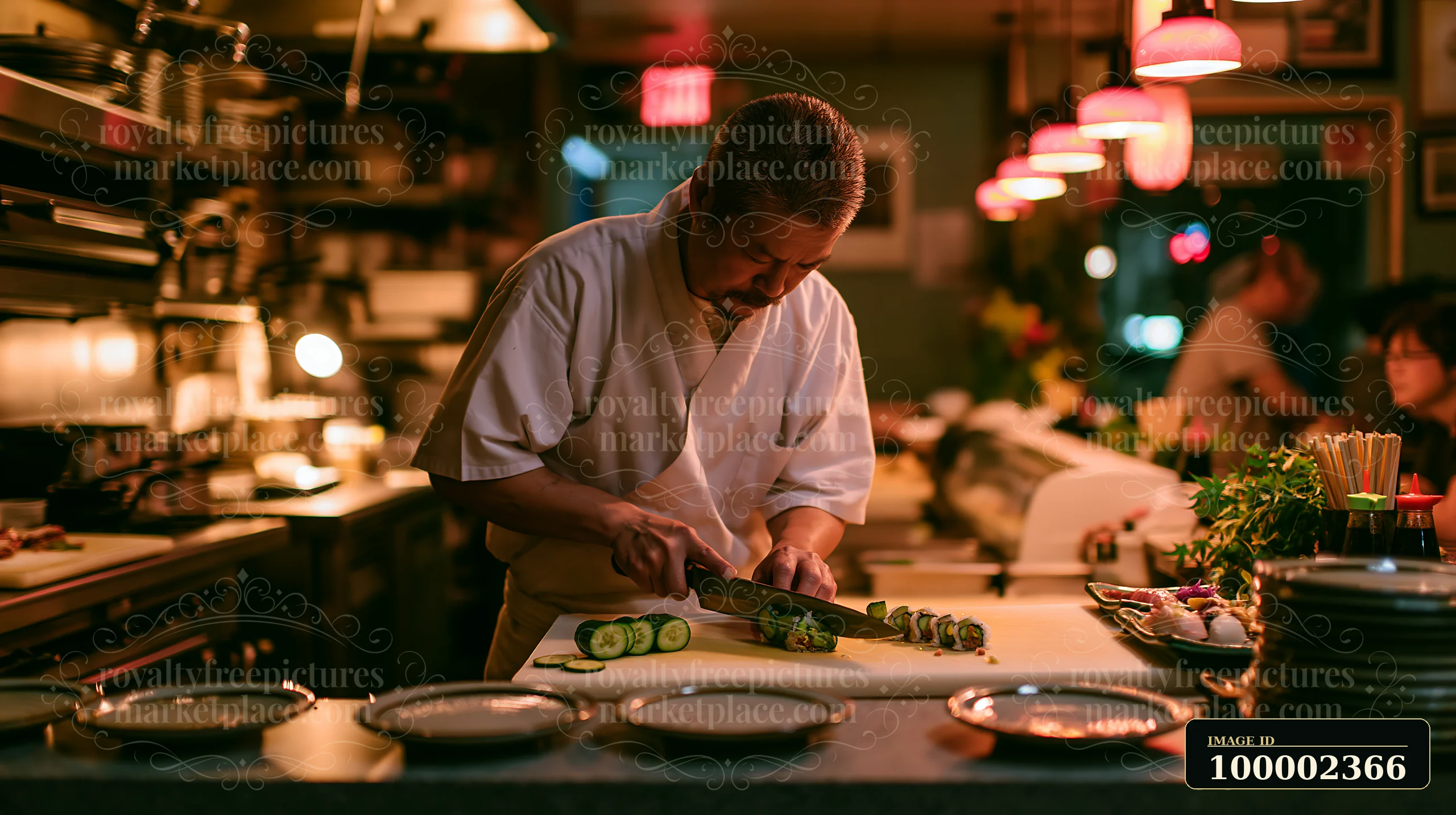A chef slices sushi rolls in a warm, softly lit restaurant.