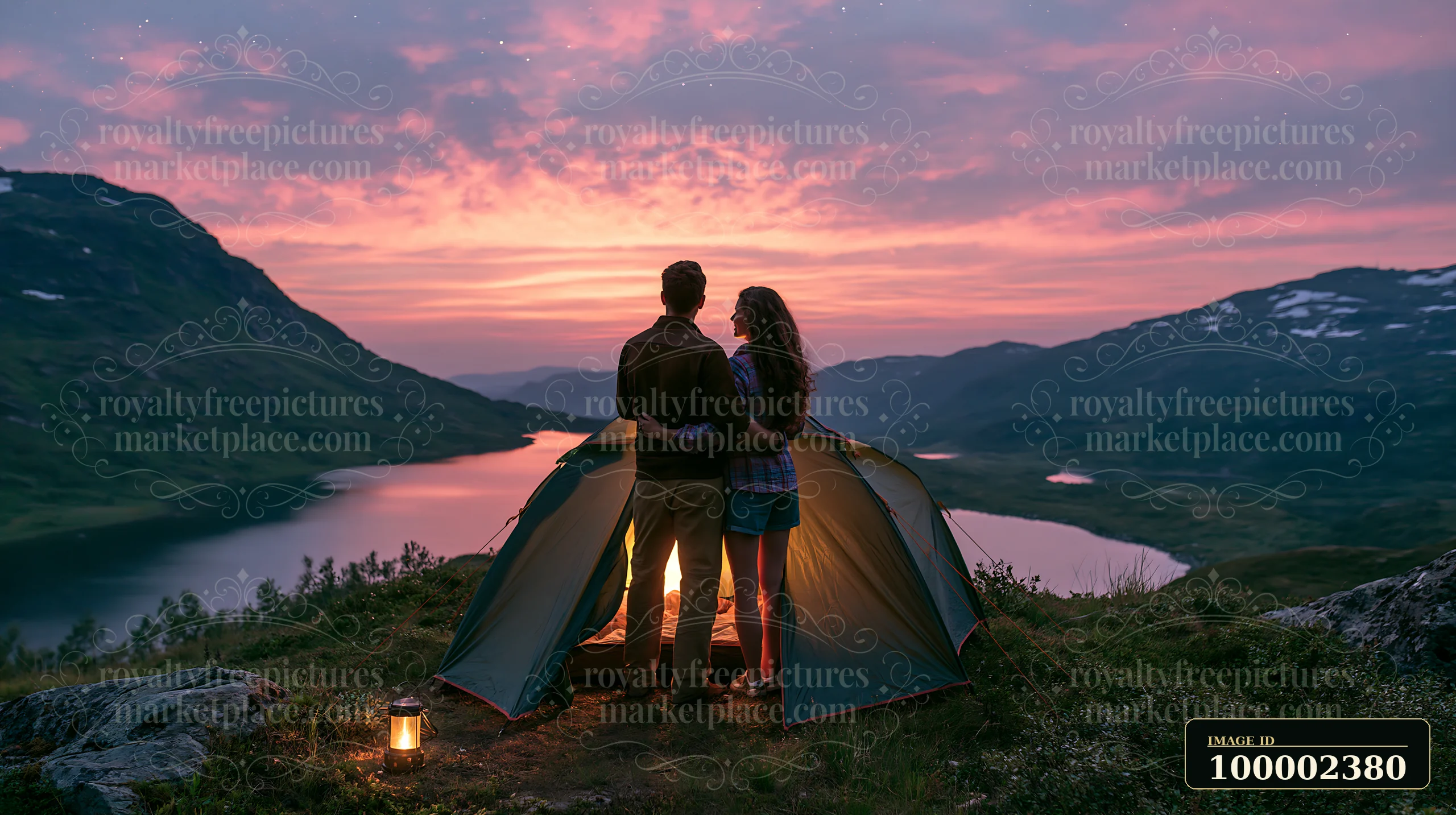 A couple camping under a star-filled sky stands near their tent as evening settles in.