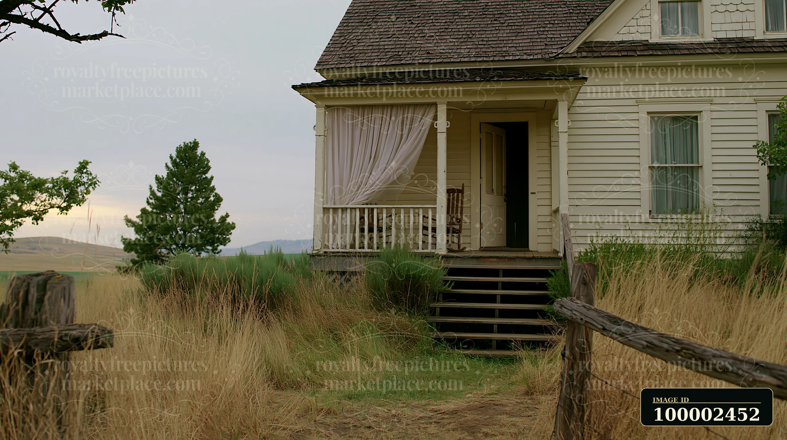 A country house with an open front door shows a welcoming entrance and a porch with a rocking chair.
