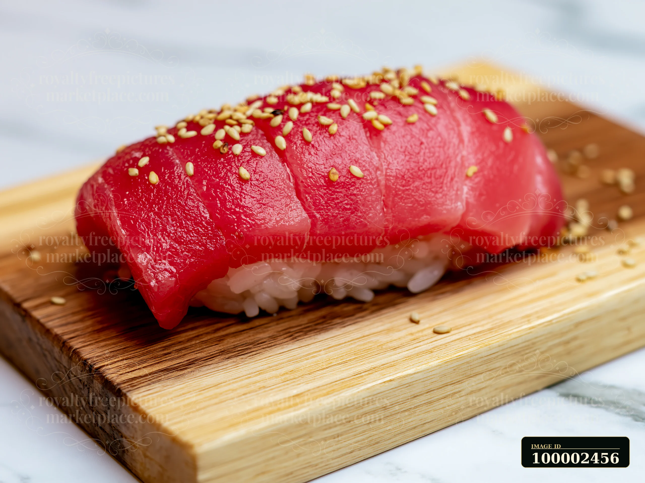 A single tuna nigiri is placed on a wooden board, showcasing the delicate slice of fish over rice.