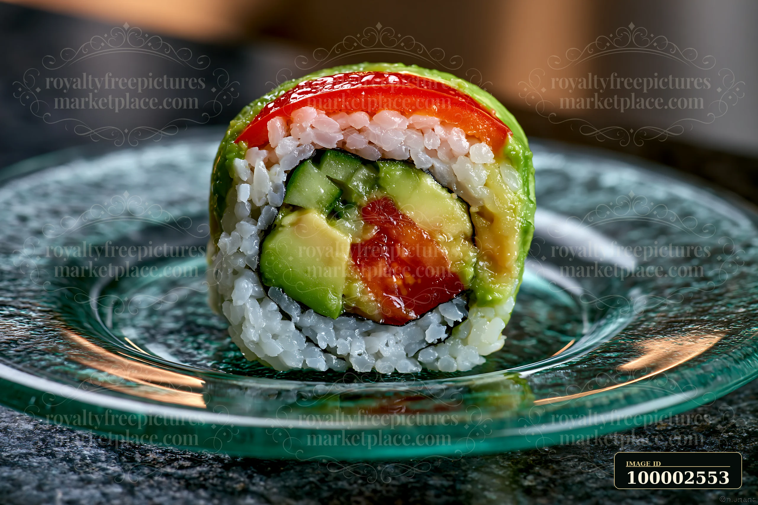 One avocado sushi roll piece sits on a glass plate.