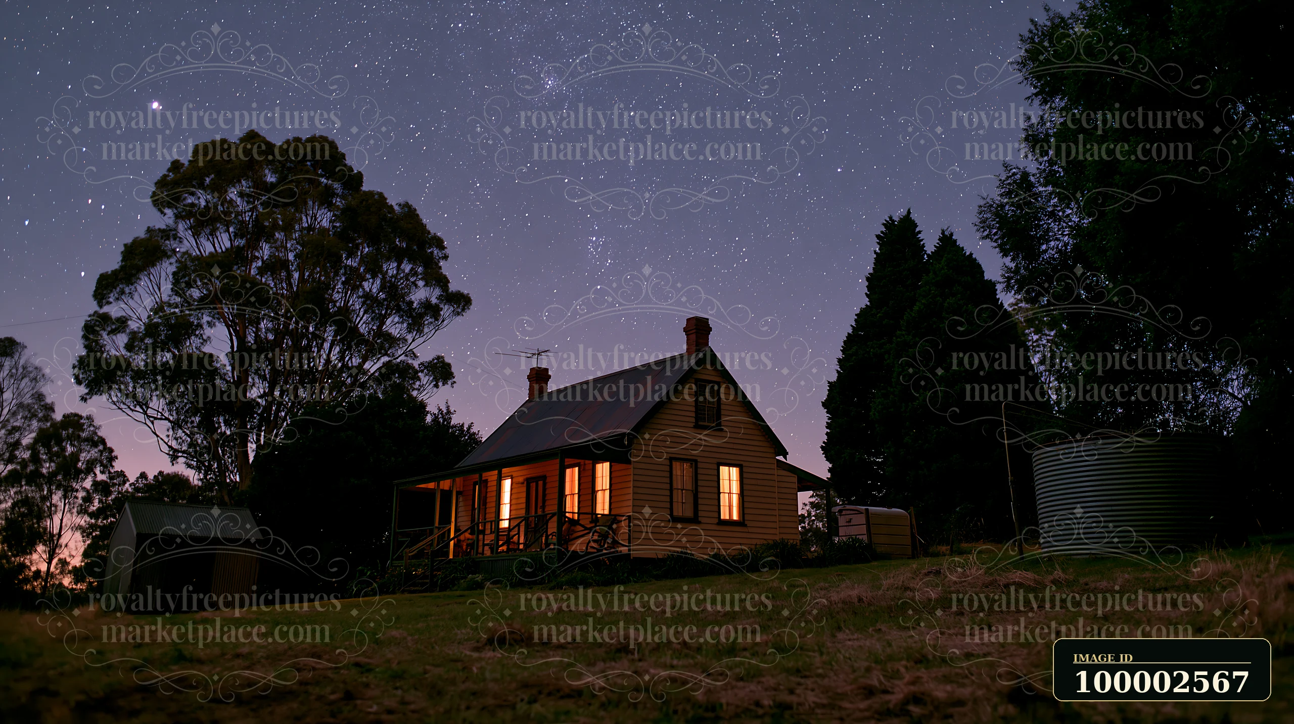 A country home sits quietly under a clear night sky filled with stars.