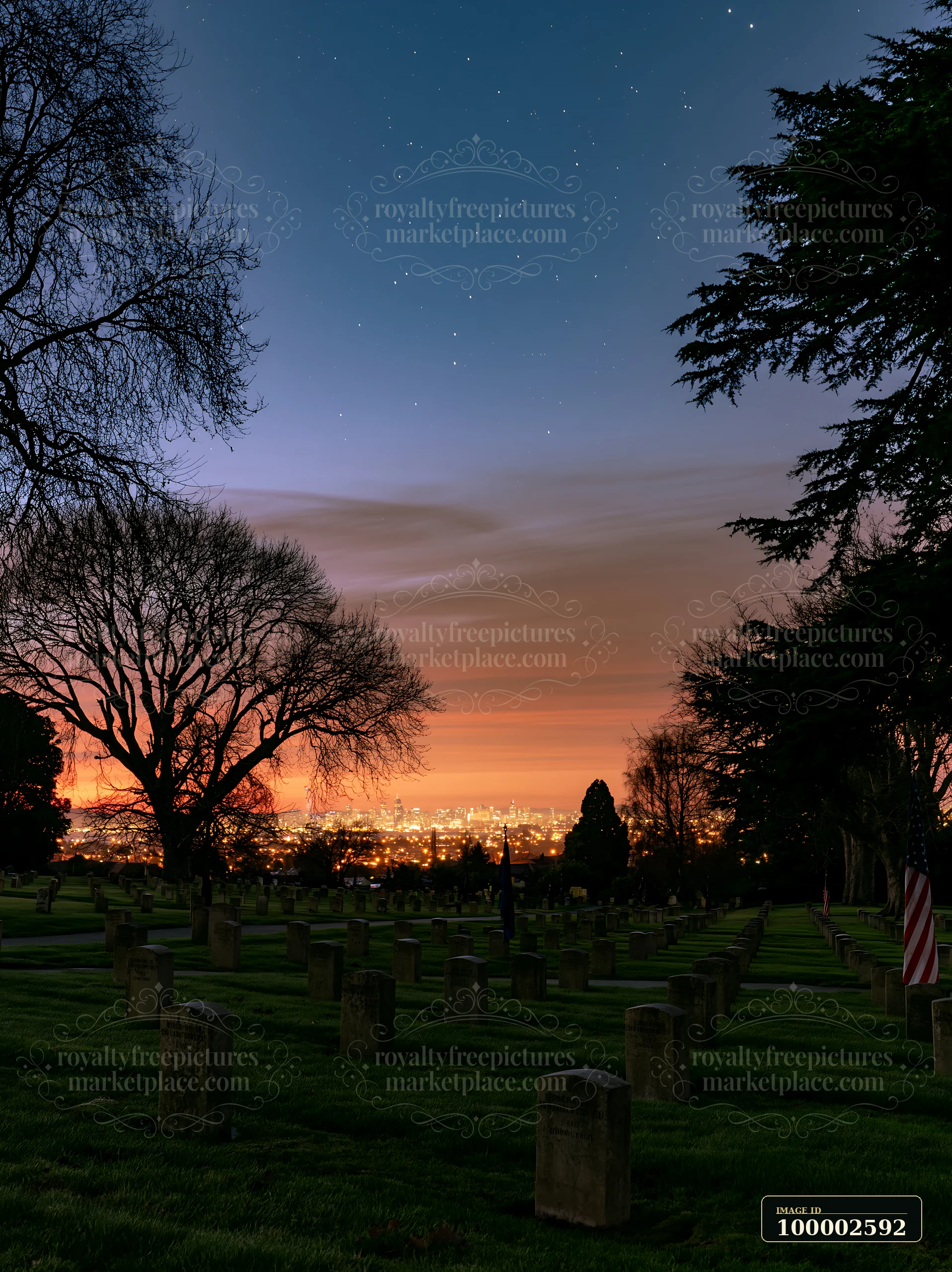 Gravestones are visible in a war cemetery with distant city lights shining under a sky filled with stars.