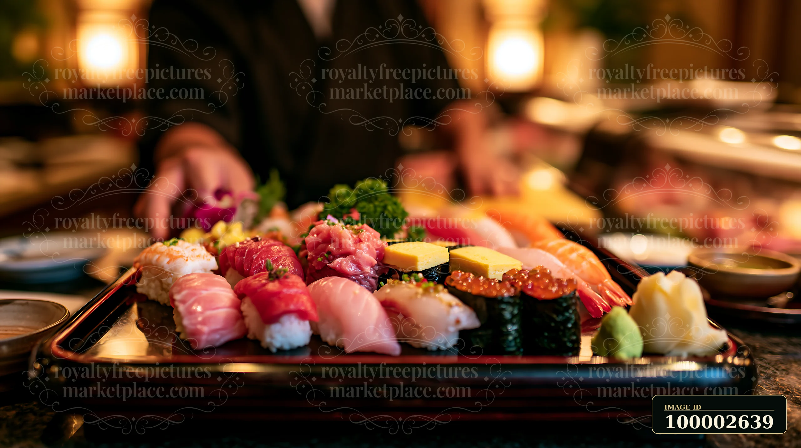 A variety of sushi including rolls and sashimi is displayed on a wooden platter in a restaurant.