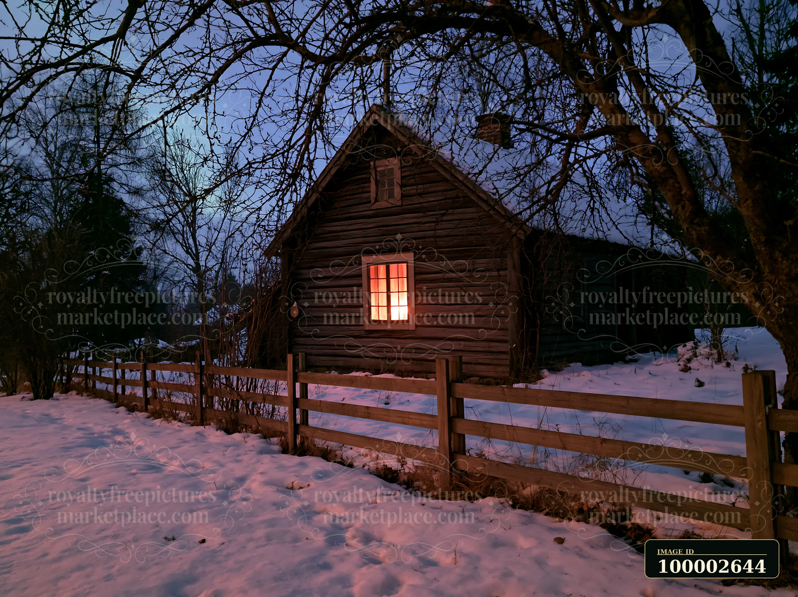 A wooden cottage sits under the night sky illuminated by northern lights.