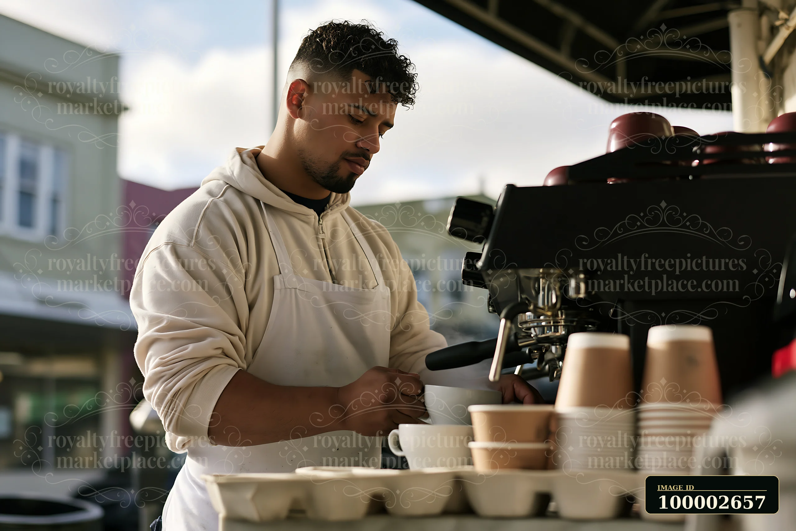 A barista steaming milk at a street cafe prepares a fresh beverage.