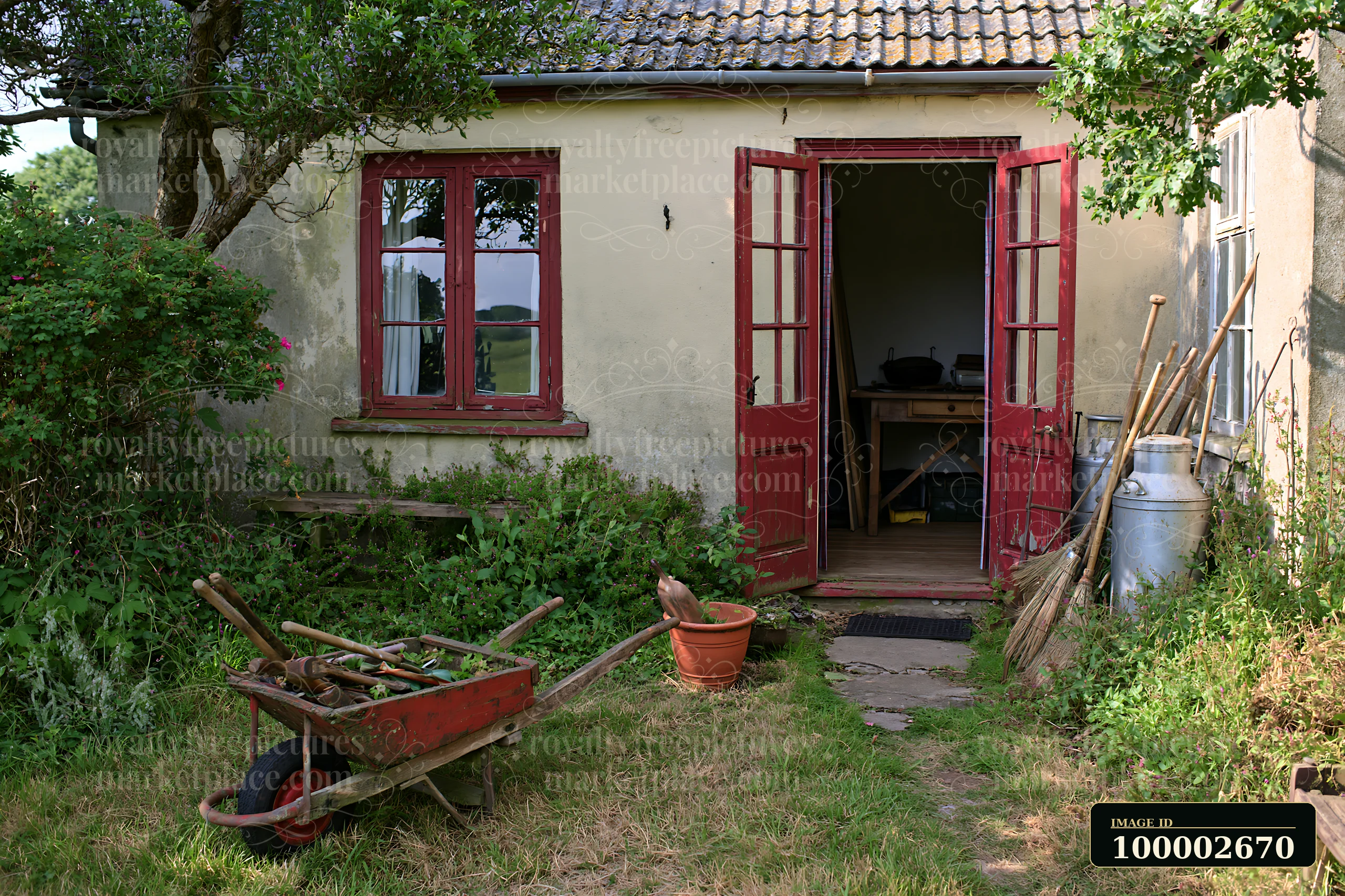 A country house with open front door shows a glimpse of the interior.