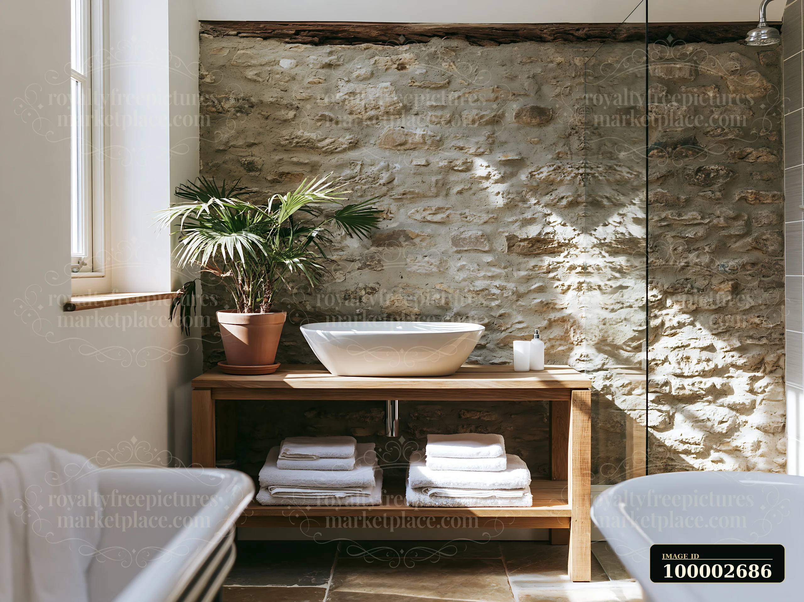 A cozy bathroom shows an exposed stone wall with a wooden vanity and a bowl sink.