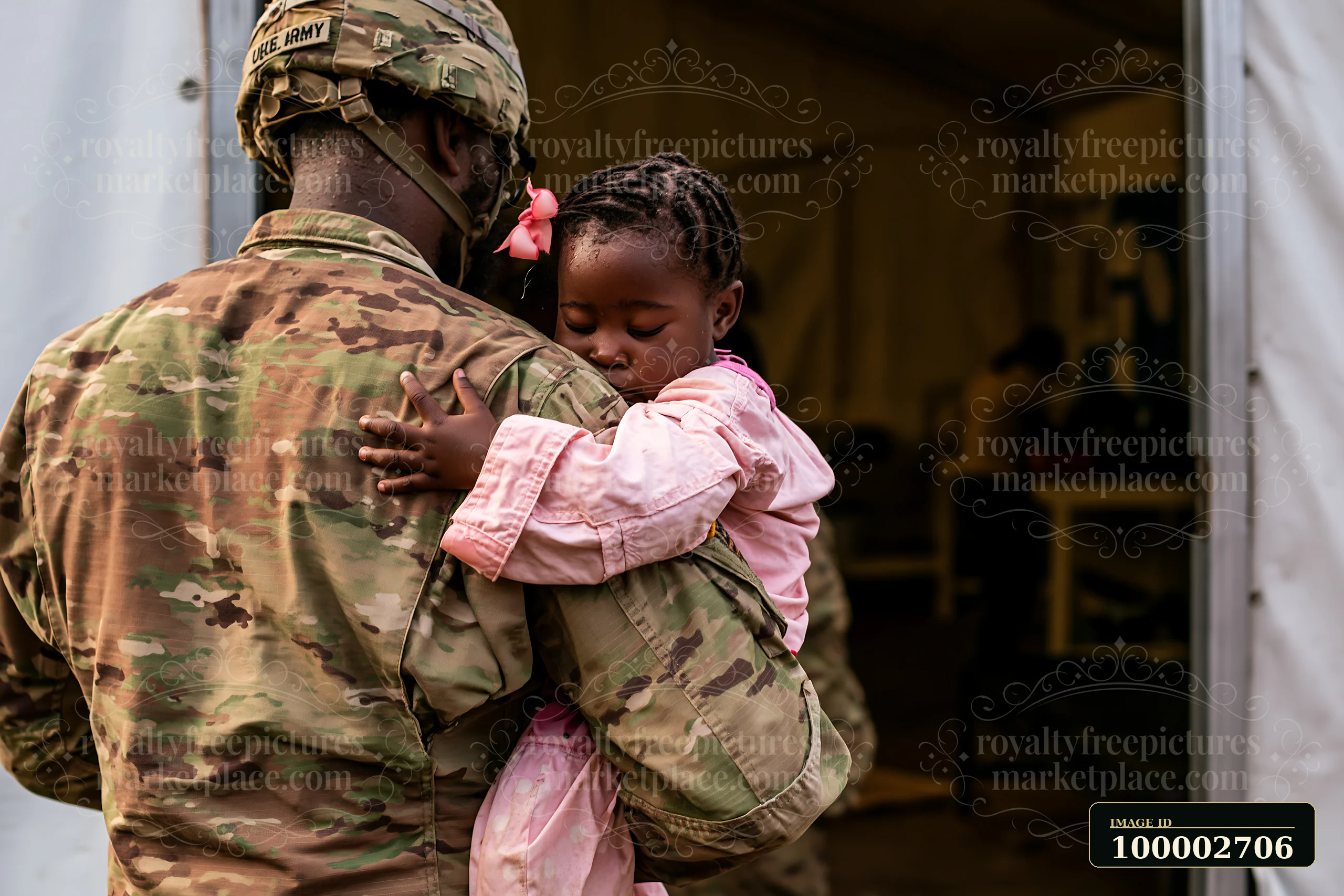 A soldier hugs a child in a military camp, showing affection and care.