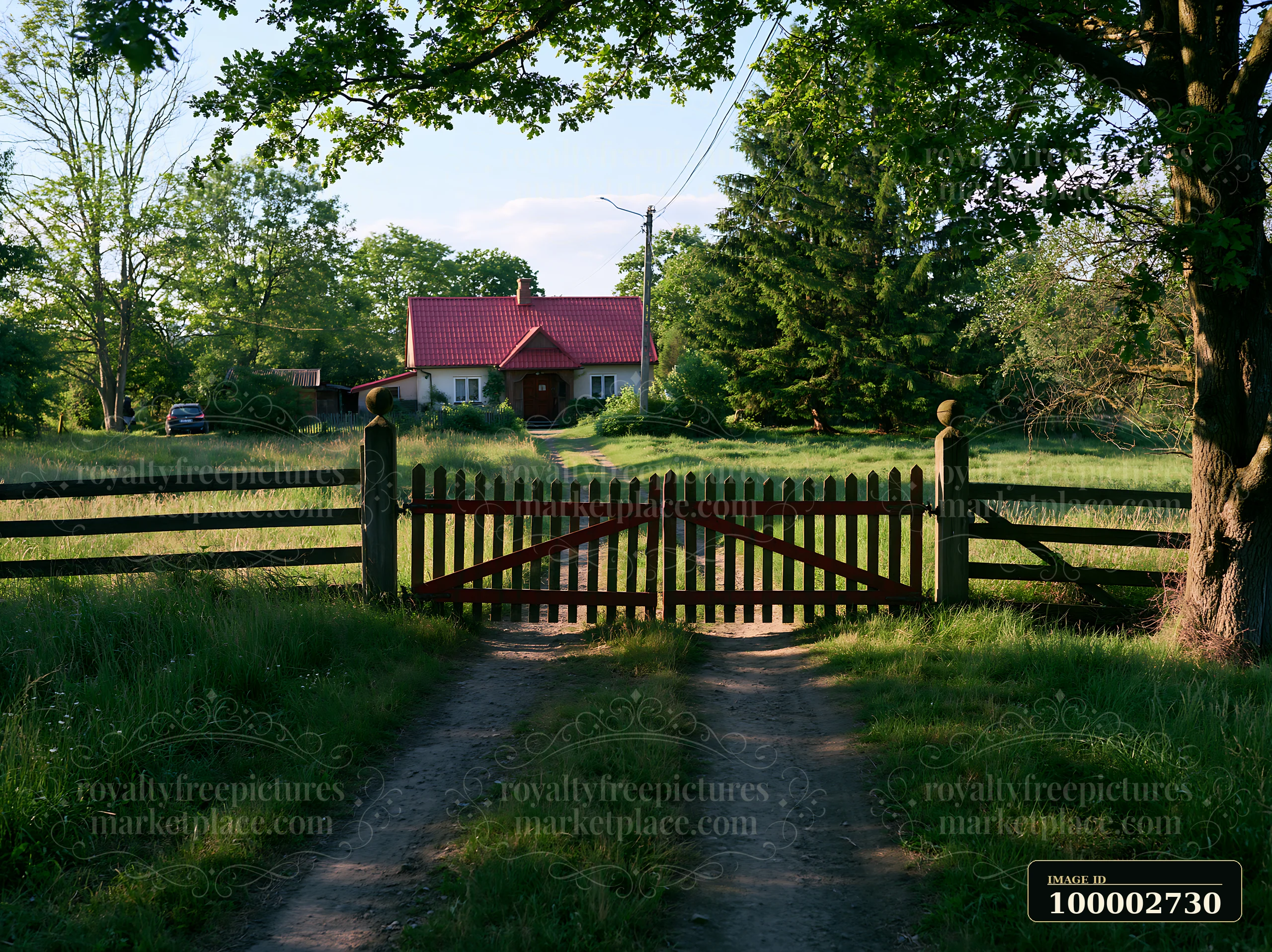 A rural cottage is visible through an open wooden gate, surrounded by green grass and trees.