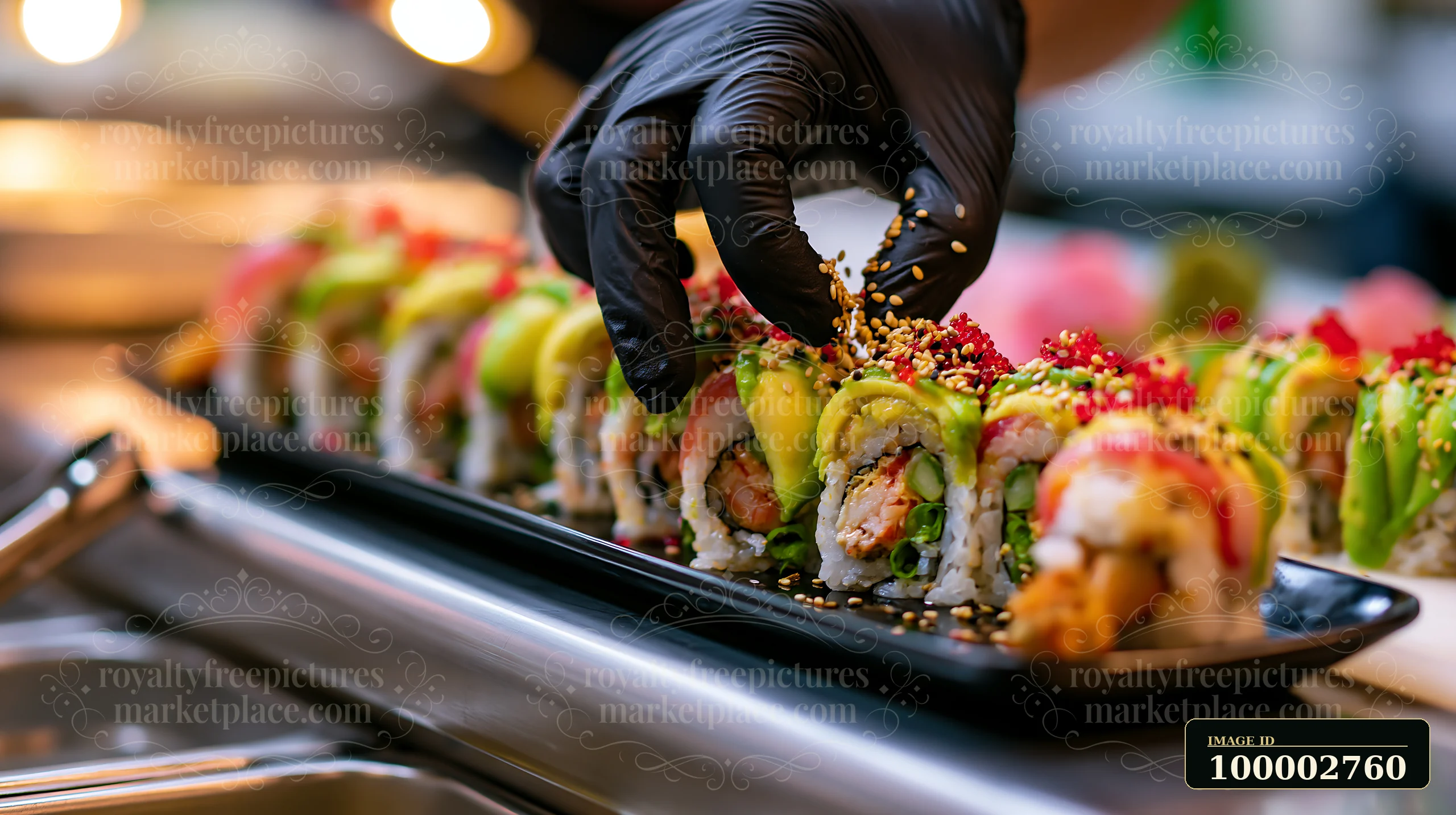 A chef places sesame seeds on a dragon roll filled with shrimp and avocado in a sushi restaurant.