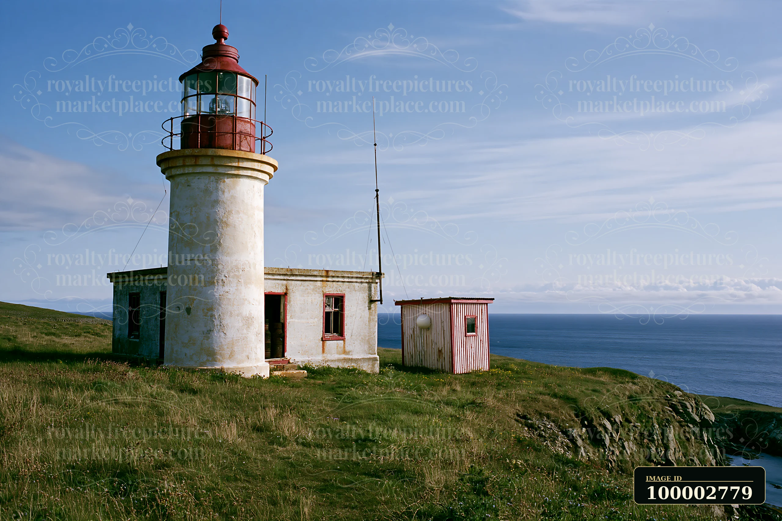 An abandoned lighthouse on a remote coast stands on a grassy hill overlooking the ocean.