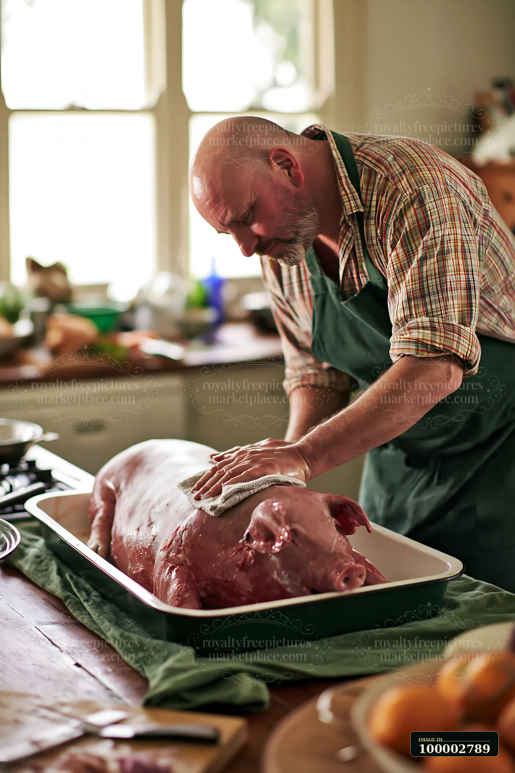 A man is cleaning a whole pig in a rural kitchen, preparing for a pig roast preparation in rural kitchen.