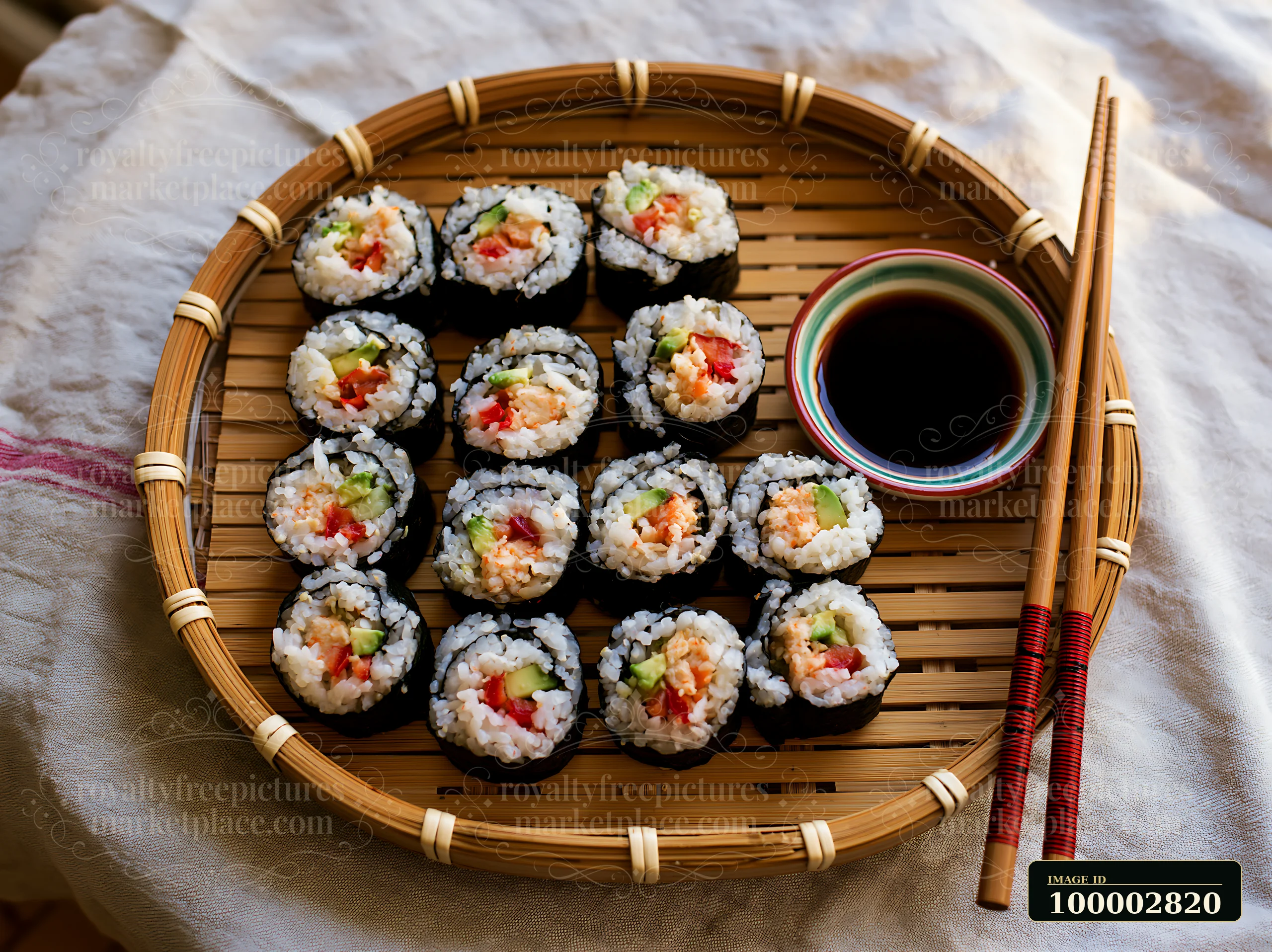 Sushi rolls served on bamboo tray with a small bowl of soy sauce.