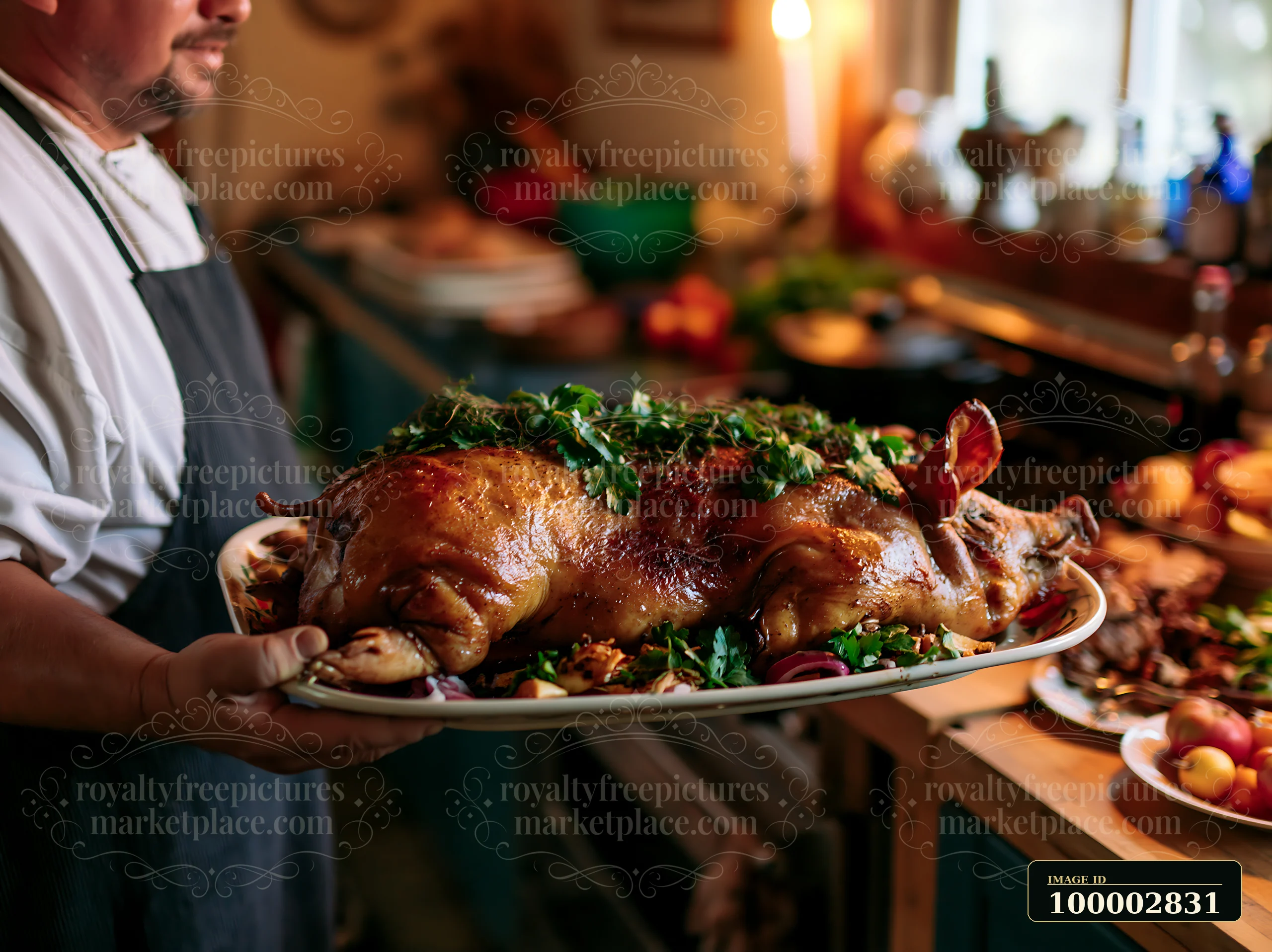 A cook holds a platter with a roast pig garnished with fresh herbs in a kitchen.
