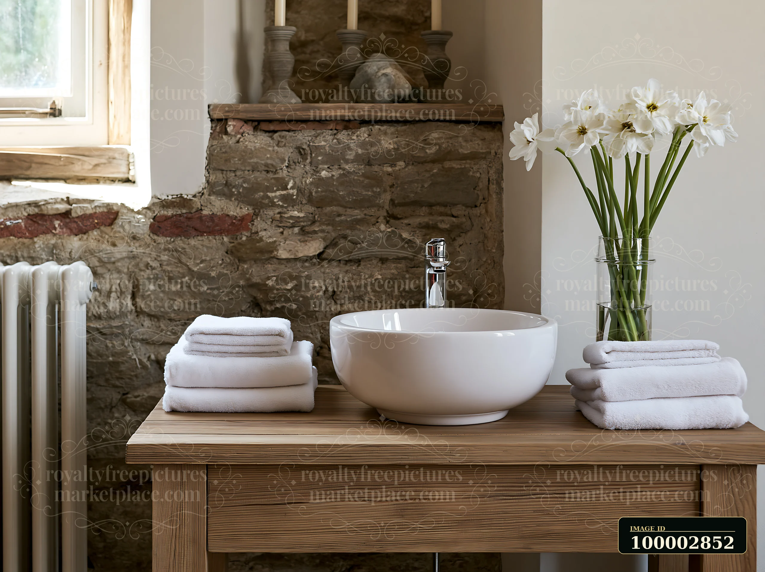 This farmhouse interior features a sink on a wooden table, surrounded by neatly folded towels and a vase of flowers.