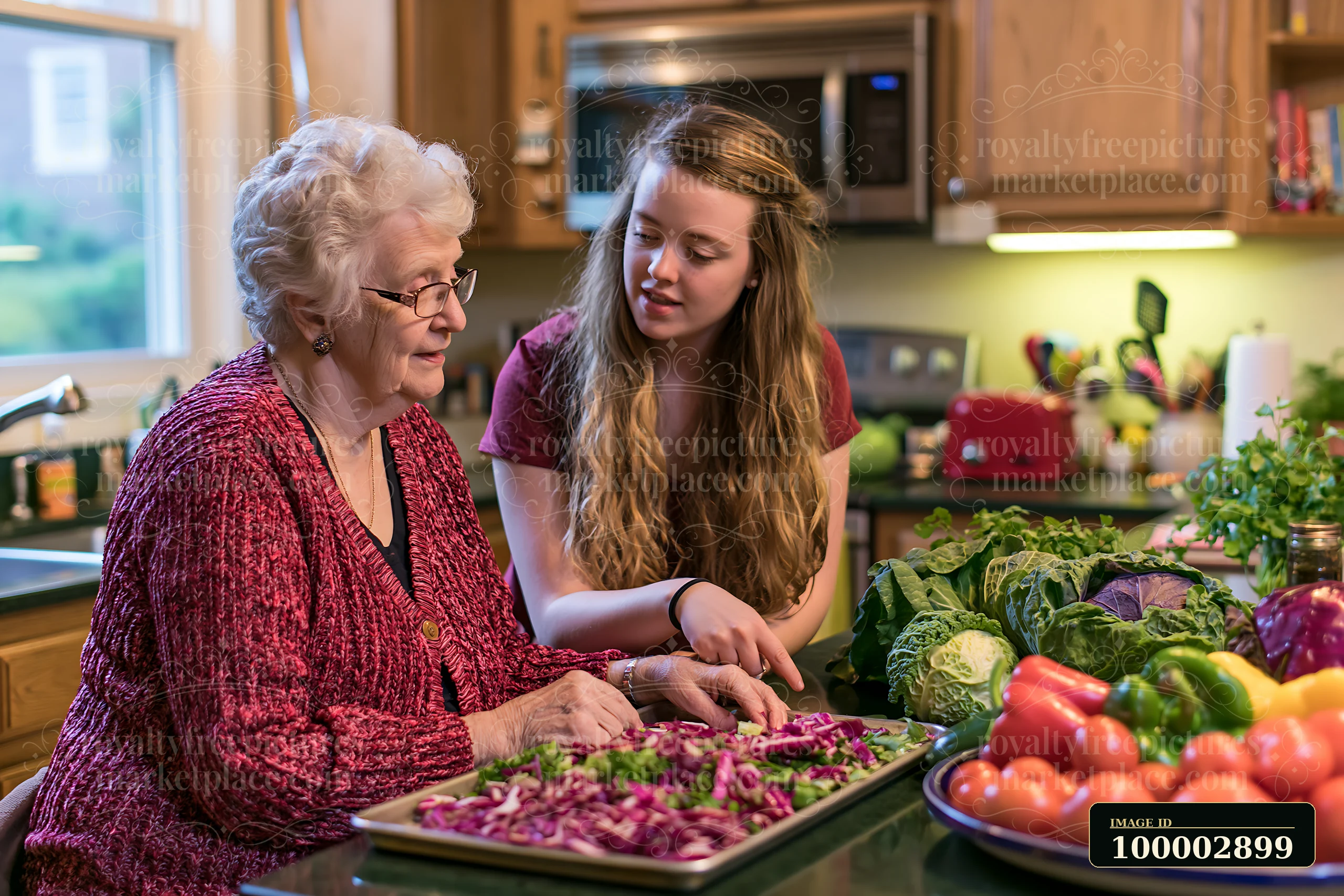 A senior woman with dementia listening to a caregiver in a kitchen setting as they prepare vegetables together.