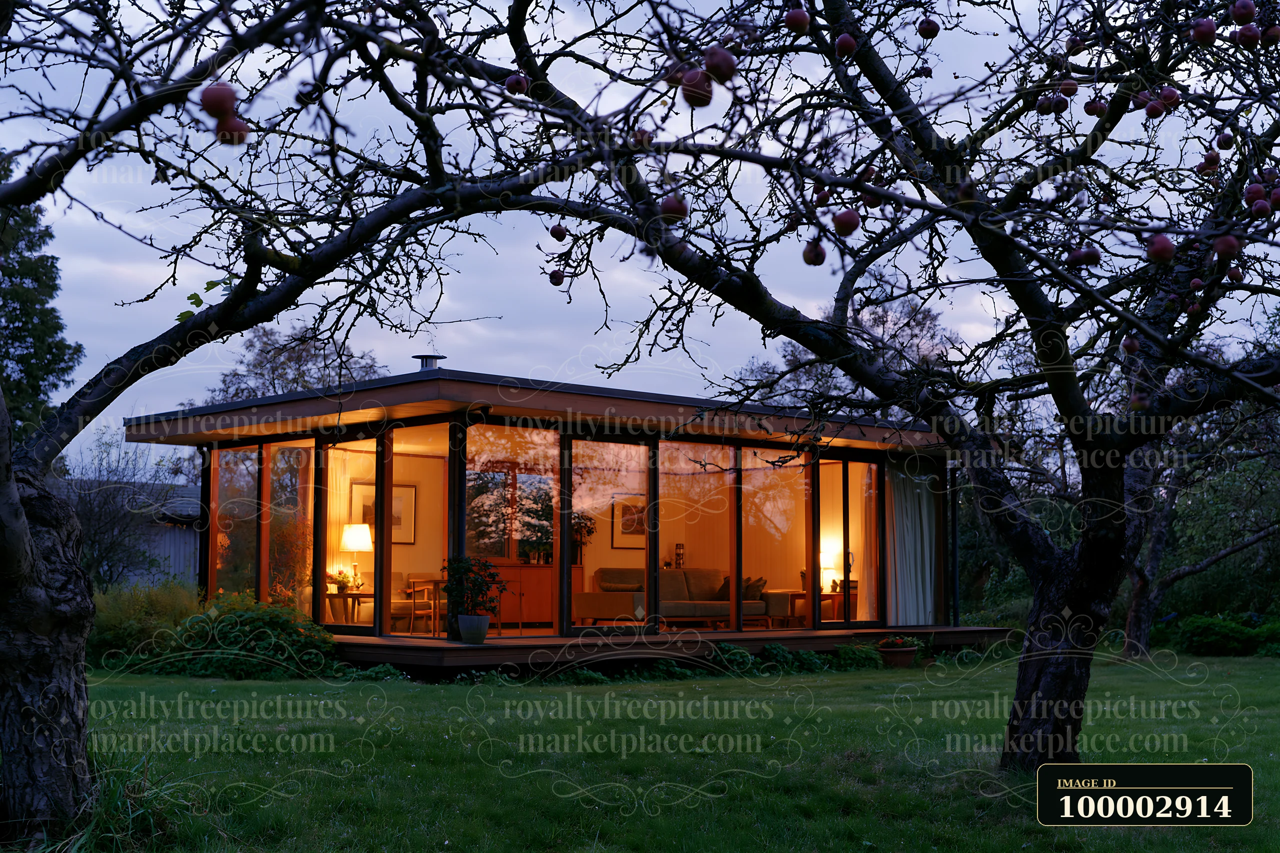 This empty garden house features glowing glass walls that highlight its interior design.