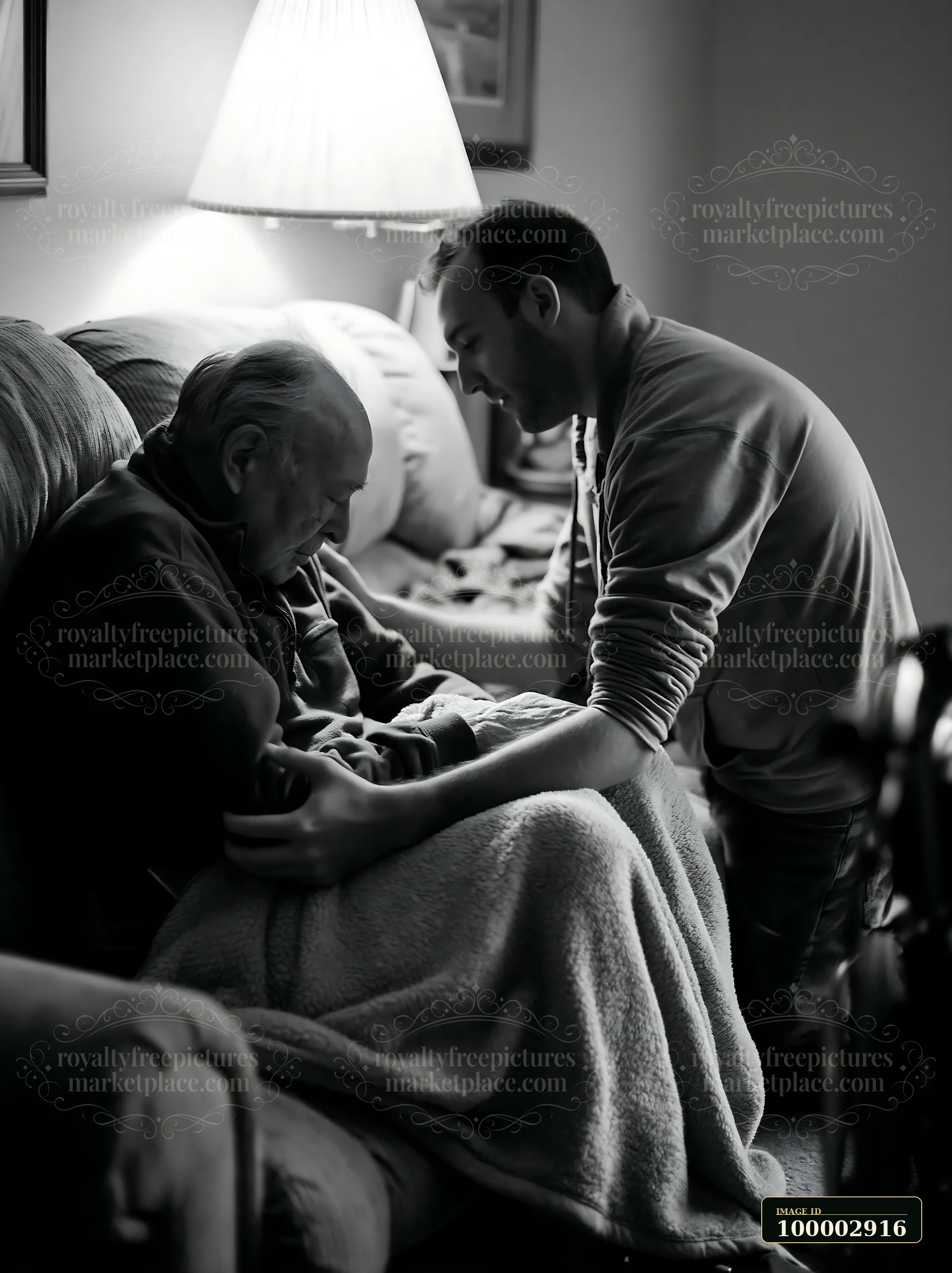 A young man interacts with an elder man seated on a couch at home.