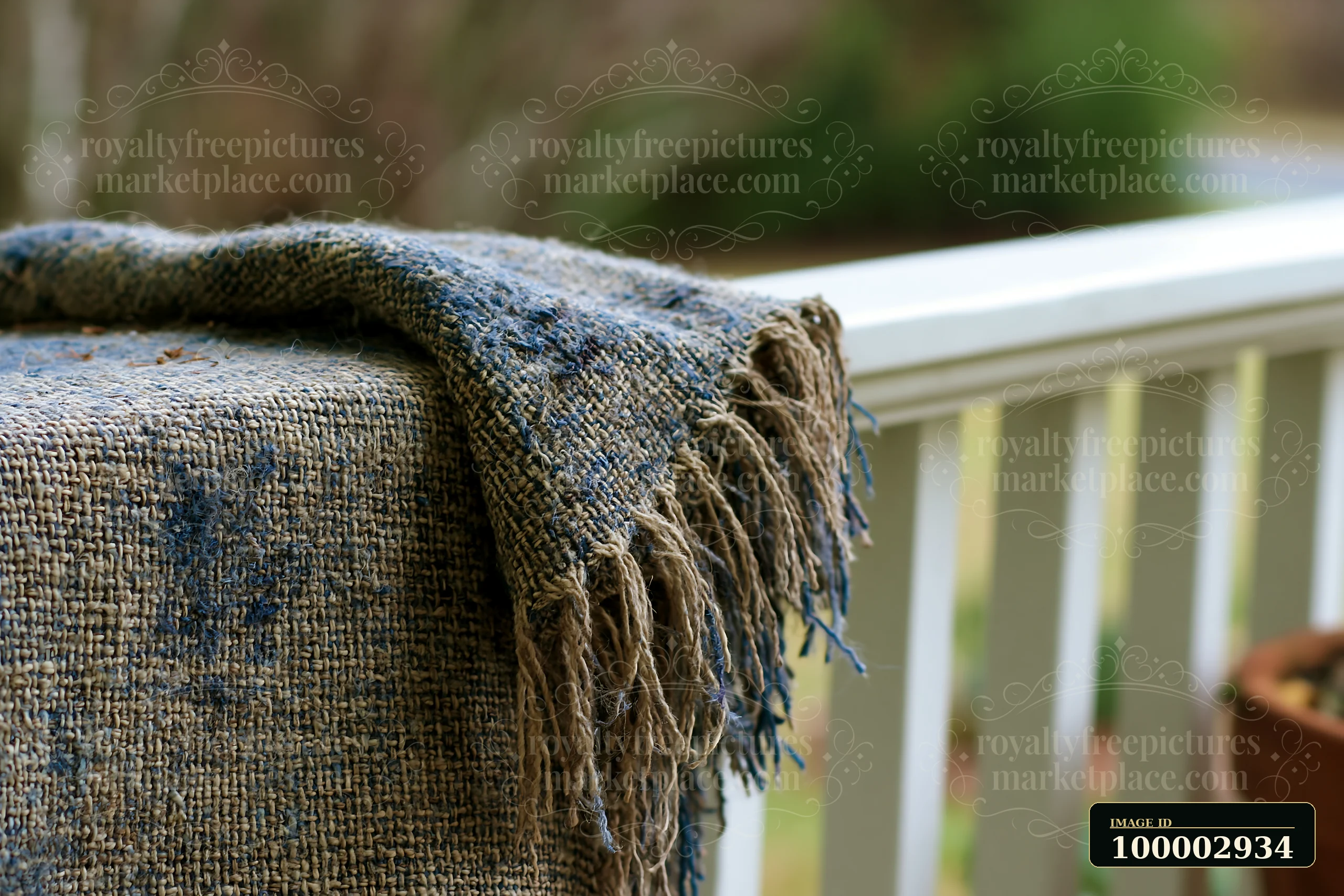 A woven fabric rests on a table at an outdoor setting.