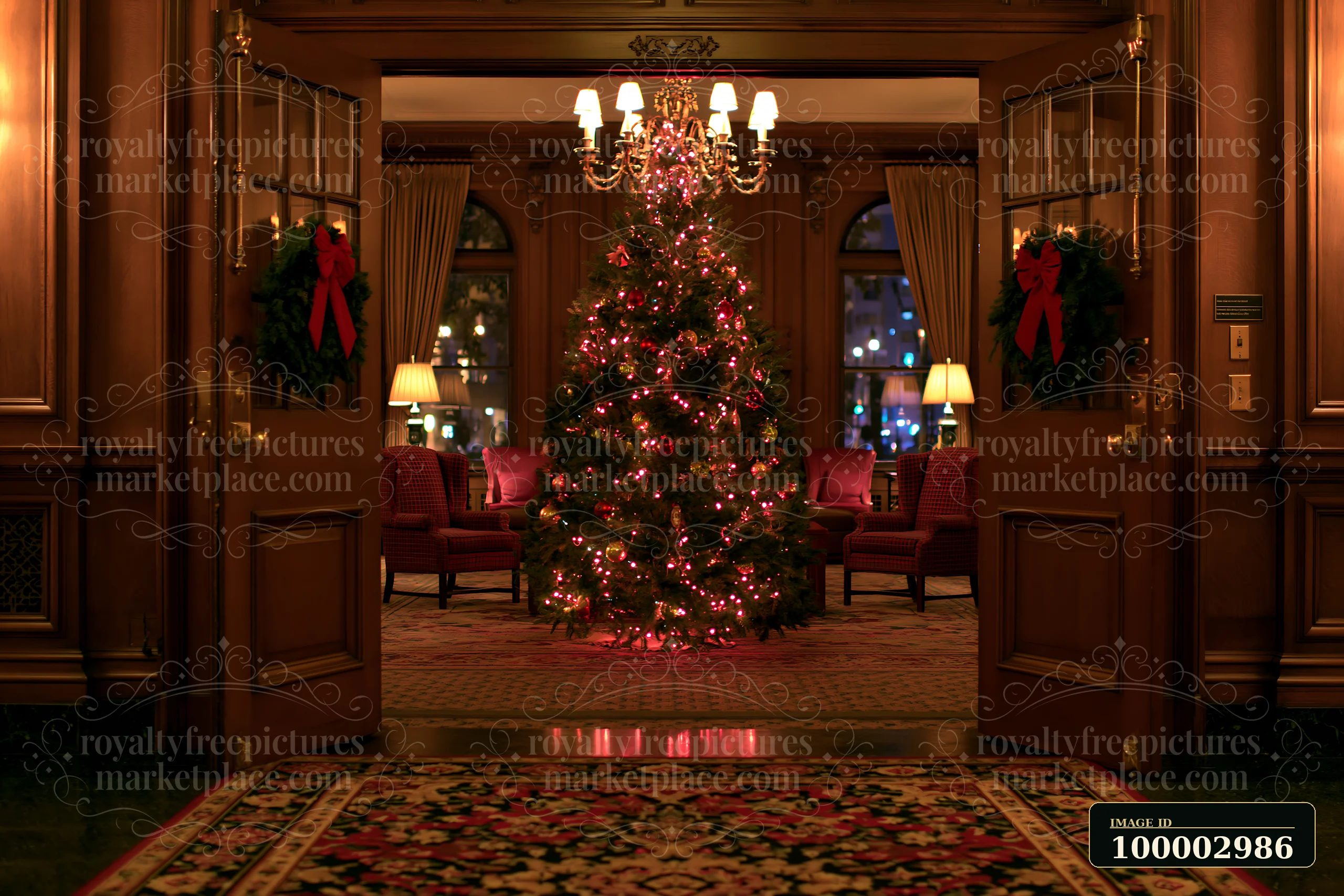 A beautifully decorated Christmas tree in a hotel lobby stands at the center, surrounded by festive decor and seating areas.
